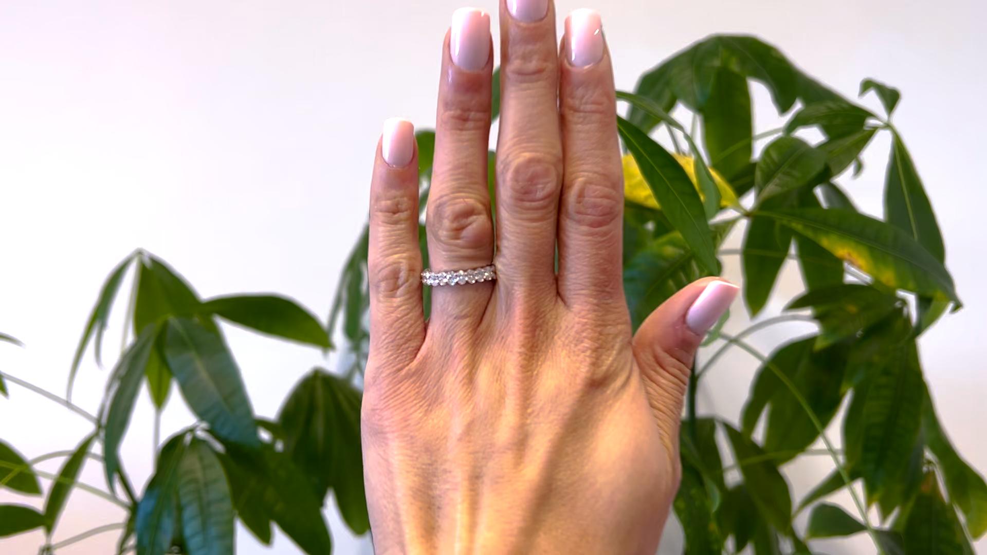 One 2.25 Carat Total Weight Oval Cut Diamond Platinum Eternity Band. Featuring 25 oval cut diamonds with a total weight of approximately 2.25 carats, graded near-colorless, VS clarity. Crafted in platinum. Circa 2020. The ring is a size 6 ½ and may