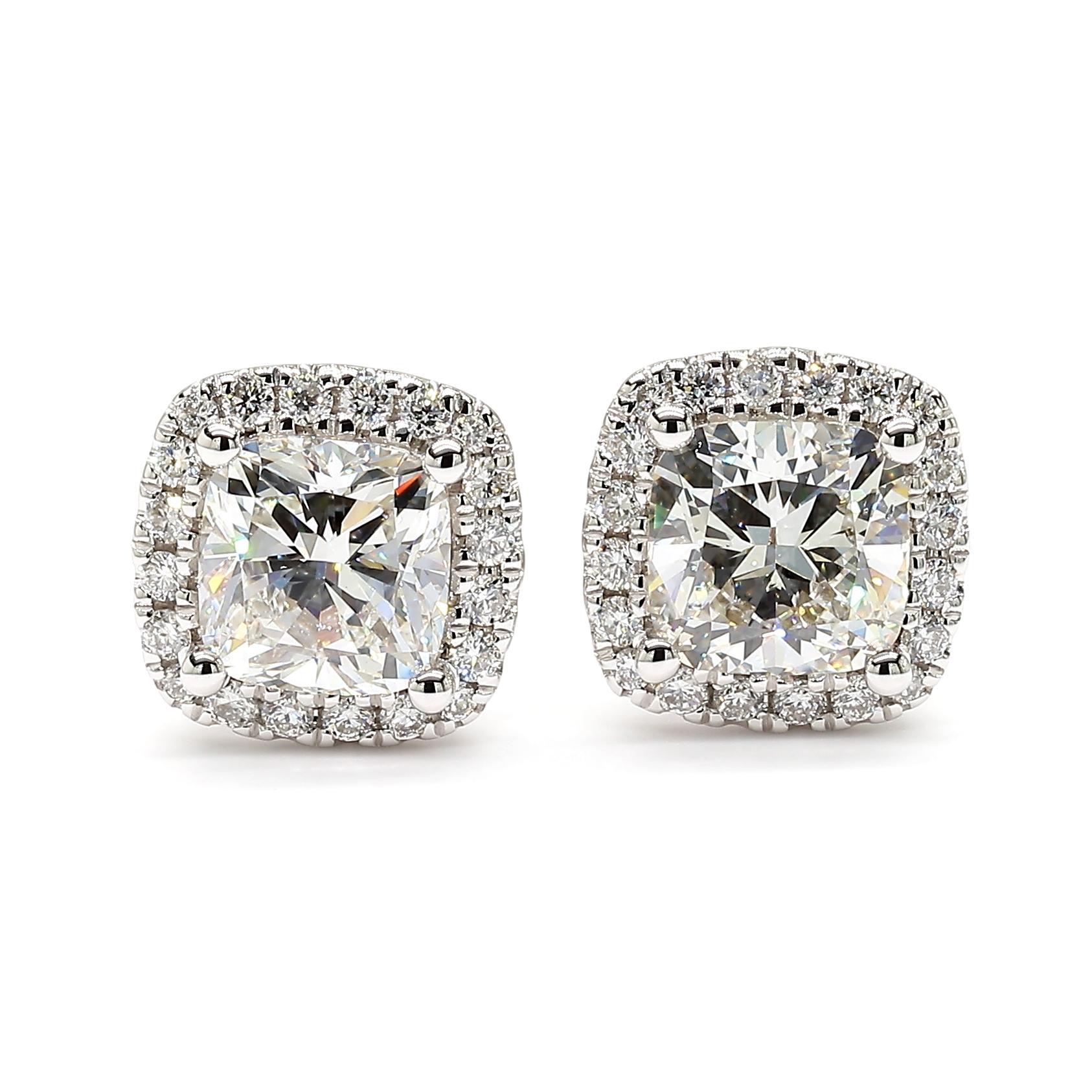 This cushion cut pair of diamond earrings with a halo is a testament to fine craftsmanship and timeless design. Perfect for those who appreciate the beauty of natural diamonds, these earrings offers a balance of luxury and tasteful simplicity.

GIA