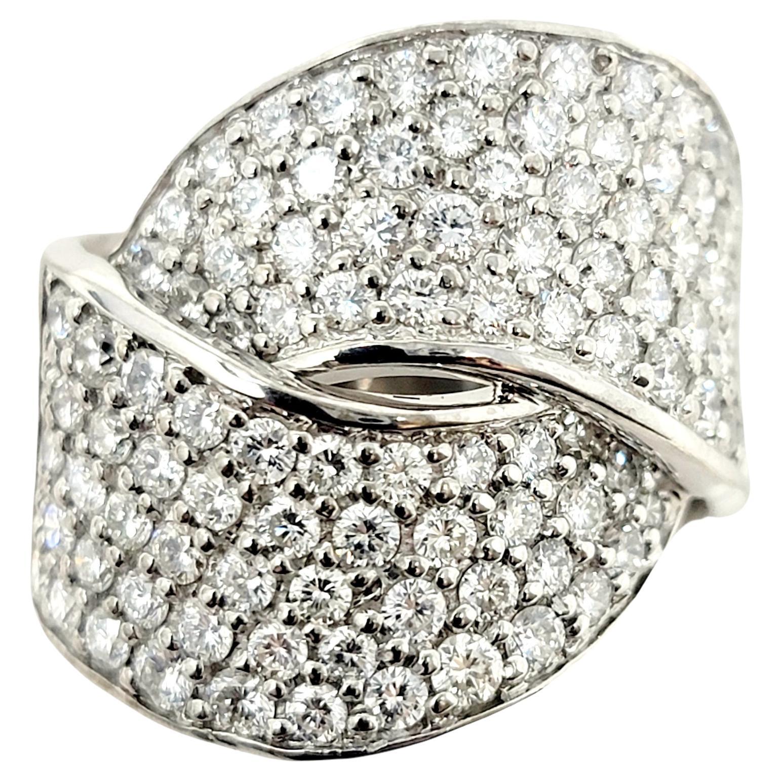 Ring size: 7.5

This stunning diamond cocktail ring wraps elegantly around the finger and fills it with sparkle from end to end. Featuring a contemporary wrap style design, the wide overlapping bands are embellished with icy white pave diamonds. The