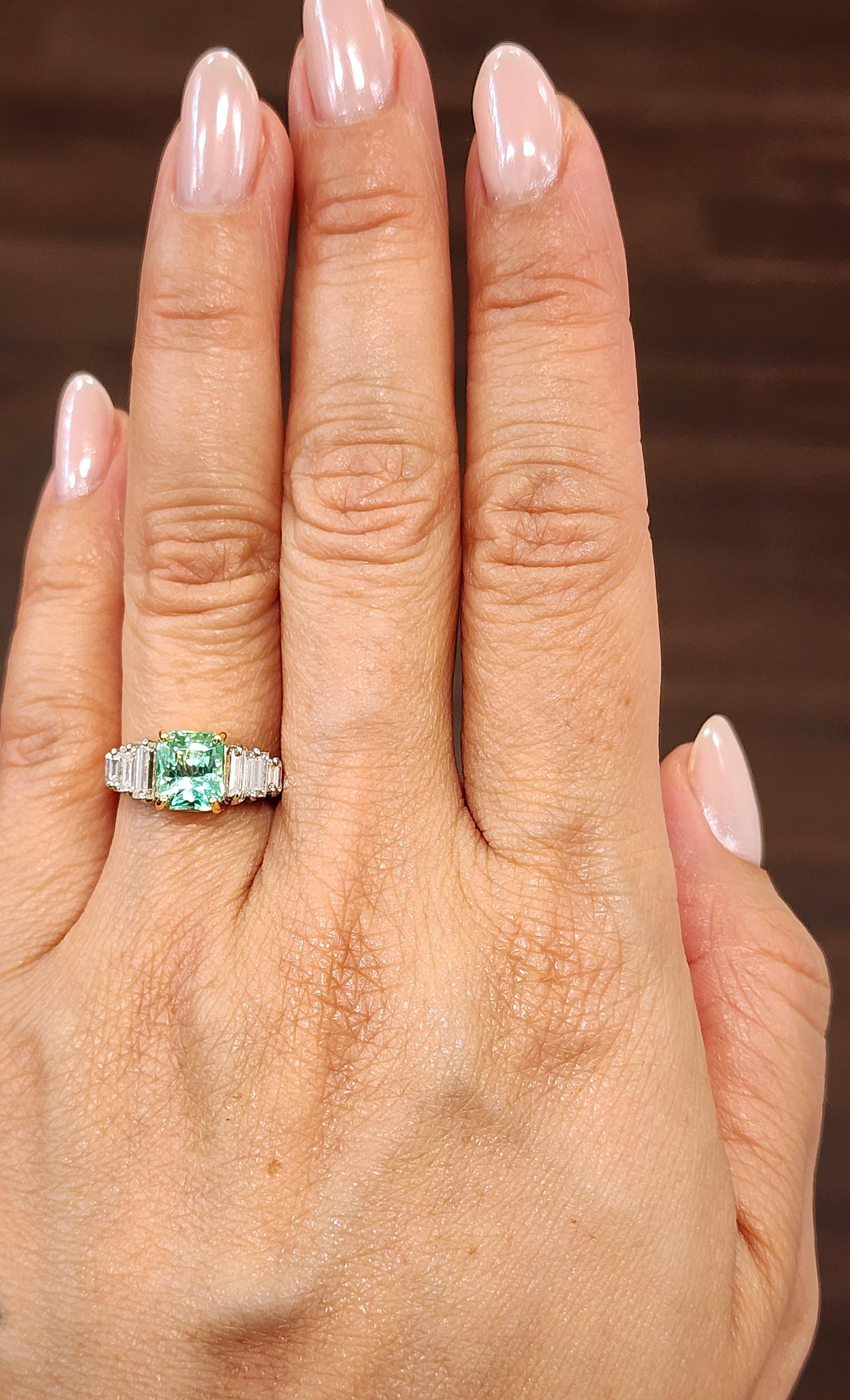 Discover this beautiful ring, featuring a 1.75 ct GIA certified Colombian emerald-cut emerald with a vibrant green hue. Flanked by approximately 0.50 ct of baguette-cut diamonds, the piece offers a striking contrast with F/G color and VS1/VS2
