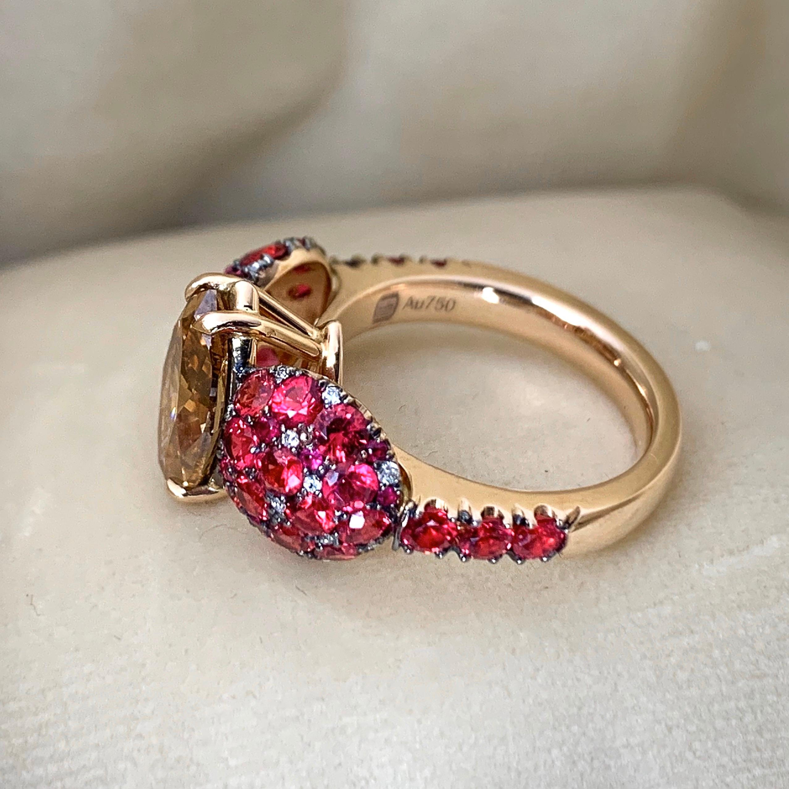 One of a kind ring handmade in Belgium by jewellery designer Joke Quick,  in 18K Rose gold 7,3 g. Set with a GIA Certified Fancy Deep Orange brown Marquise shape diamond centerstone 2,25ct. VS2, pave set with Unheated poppie red spinel from Mogok,