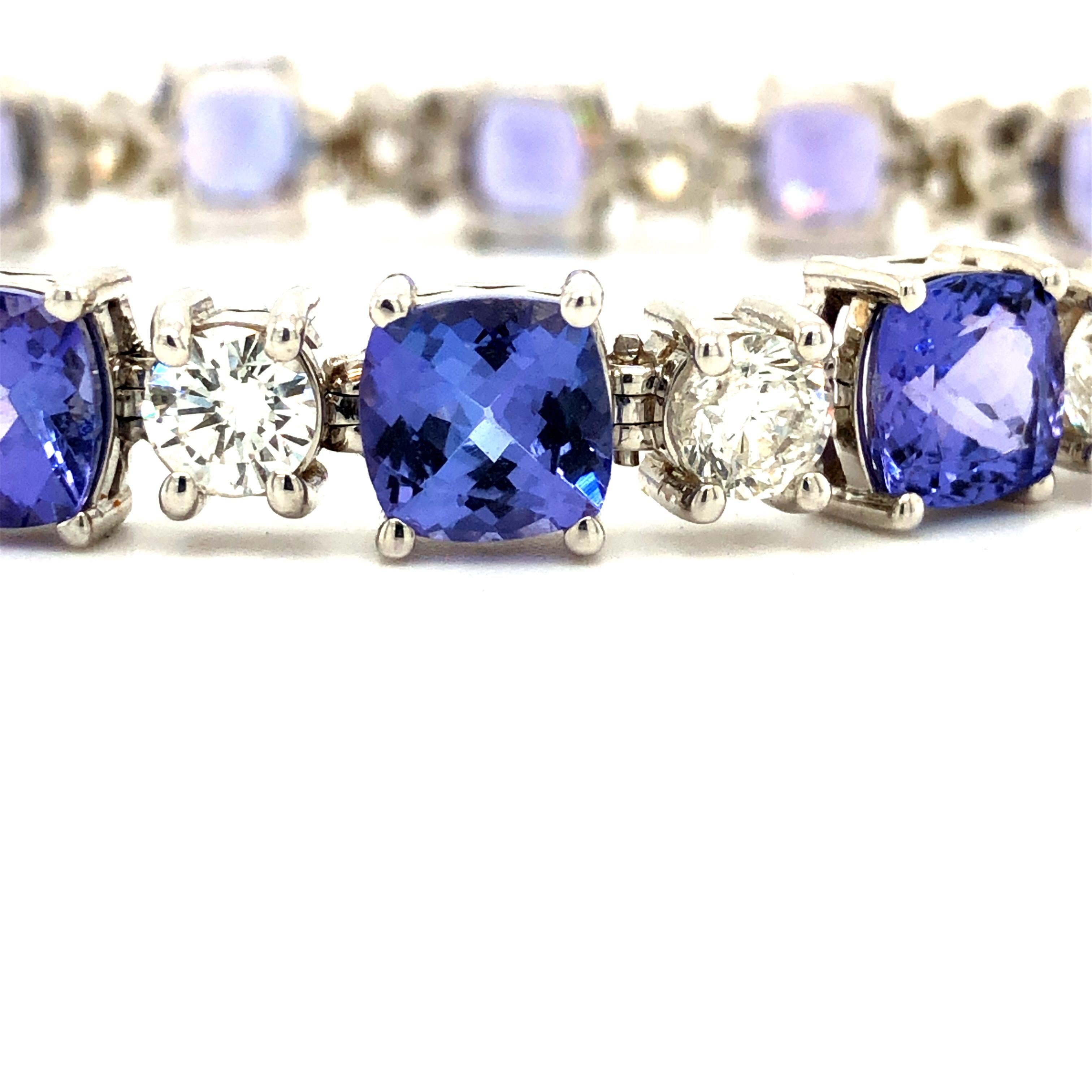 Offered here is an opulent diamond and tanzanite bracelet.
Featuring 15 natural earth mined cushion cut Tanzanites, weighing 22.50 carats total, full of sparkle beautiful lavender purple in colors, interchanged with 15 natural earth mined large