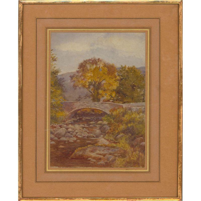 A charming watercolour painting by O.W. Staples. The scene depicts Tal-y-Bont Bridge, located in Tal-y-Bont, a small village in Conwy County Borough, Wales. Signed to the lower right-hand corner. Signed to the lower right-hand corner. Well-presented