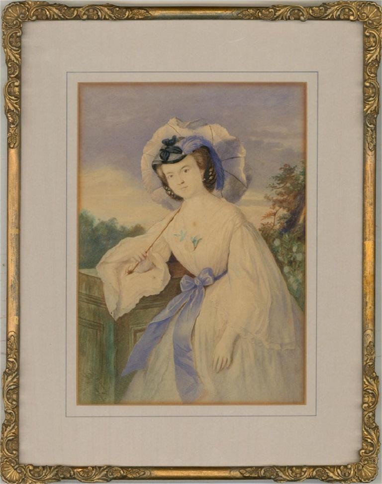 A fine watercolour portrait of a fashionably dressed Italian woman. She wears a blue ribbon around her waist and carries a delicate parasol. Presented glazed in a pale blue mount and a gilt-effect wooden frame with ornate scallop shell and acanthus