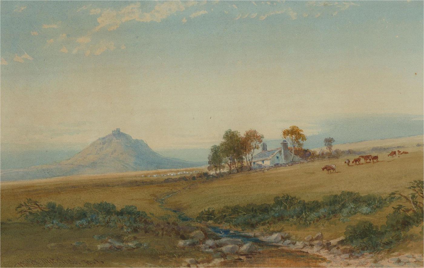 A Dartmoor landscape depicting the view of Brent Tor from Black Down. Presented glazed in a white mount with gold detailing and a distressed gilt-effect wooden frame. Signed to the lower-left edge. There is a gallery label on the verso which