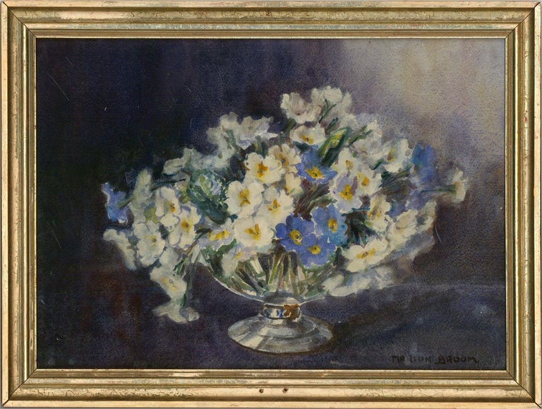 A still life depicting white and blue flowers in a glass vase. Presented glazed in a distressed gilt-effect wooden frame. Signed to the lower-right edge. On watercolour paper.
