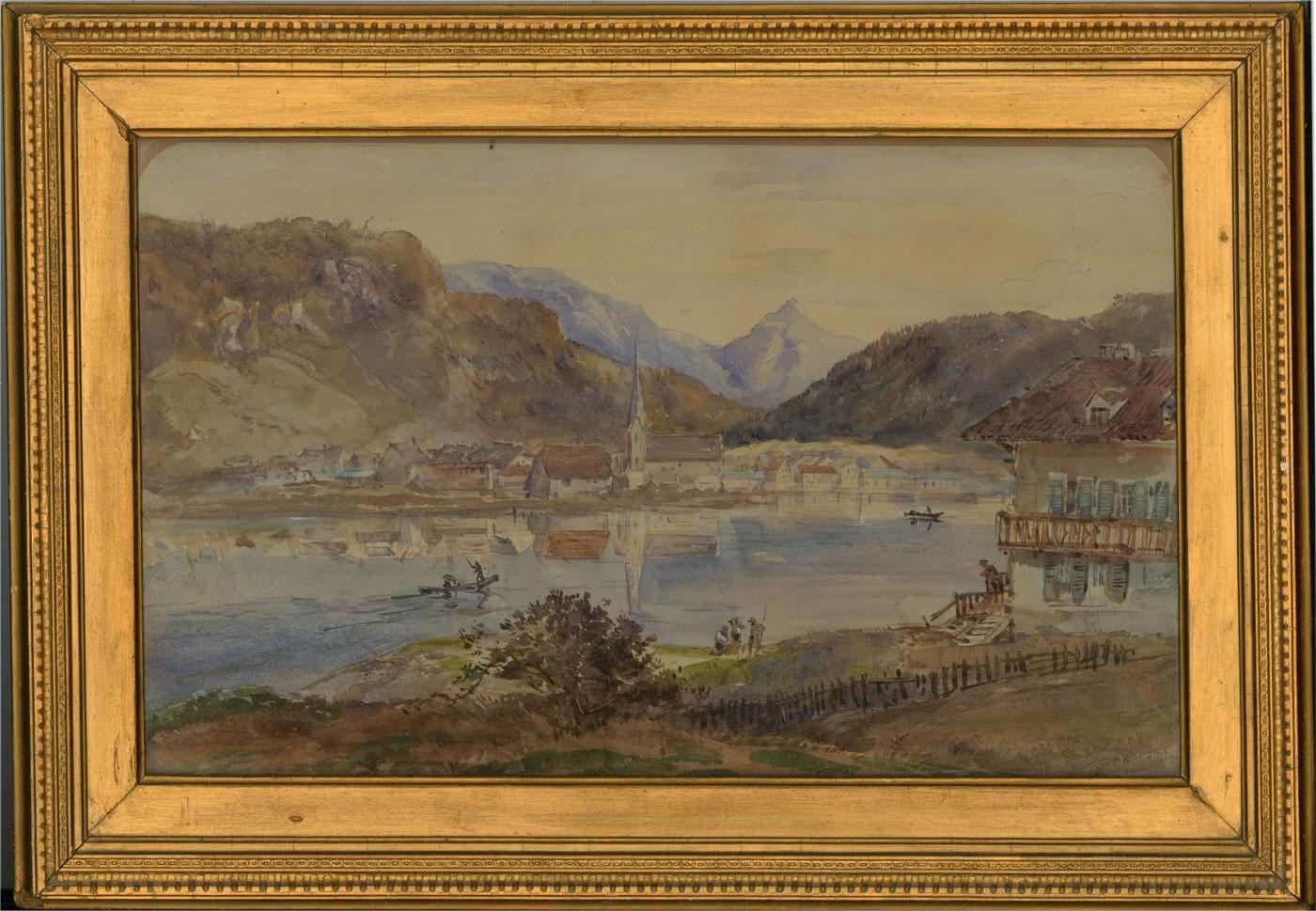 A charming Alpine watercolour showing a pretty town, nestled in the valley of the great mountains beside a clear lake. A chalet can be seen to the right in the foreground with people fishing out front. The painting is unsigned and presented in a