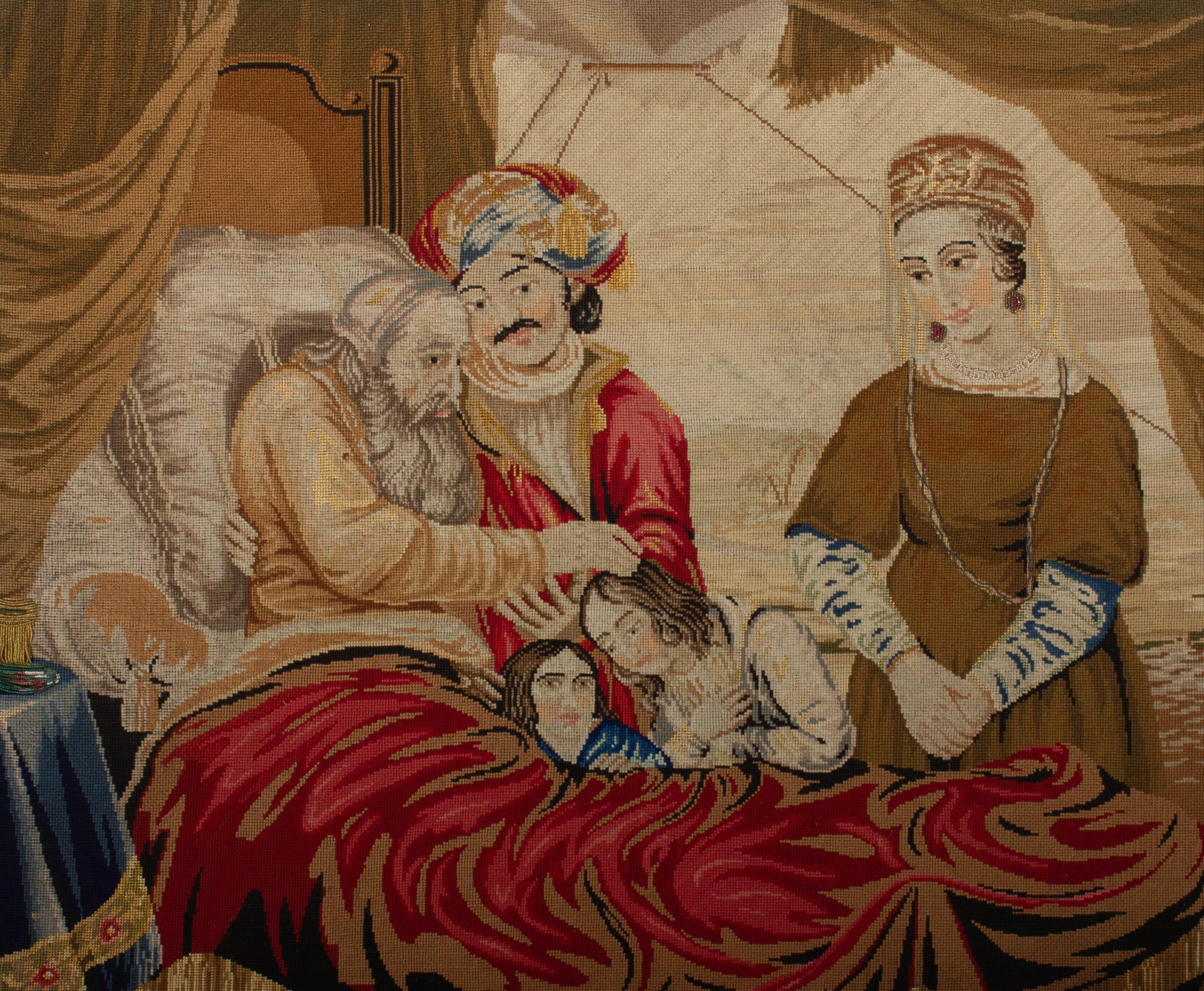 A finely detailed, early 19th Century needlepoint scene showing a family gathering round the bed of an elderly man as he blesses the children. The artwork is picked out in beautiful antique glasses beading and gold thread.
