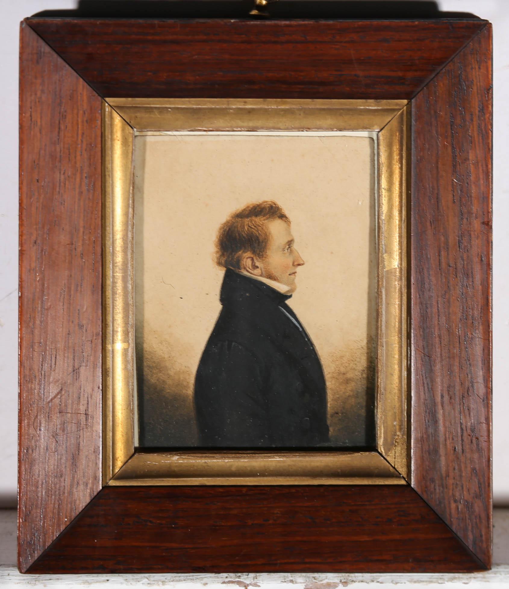 An exquisite mid 19th Century miniature portrait in watercolour, showing a handsome man in profile, with an elegantly pointed nose and a fine suit with crisp white collar. The artist's use of minuscule individual brush strokes to build up tone and