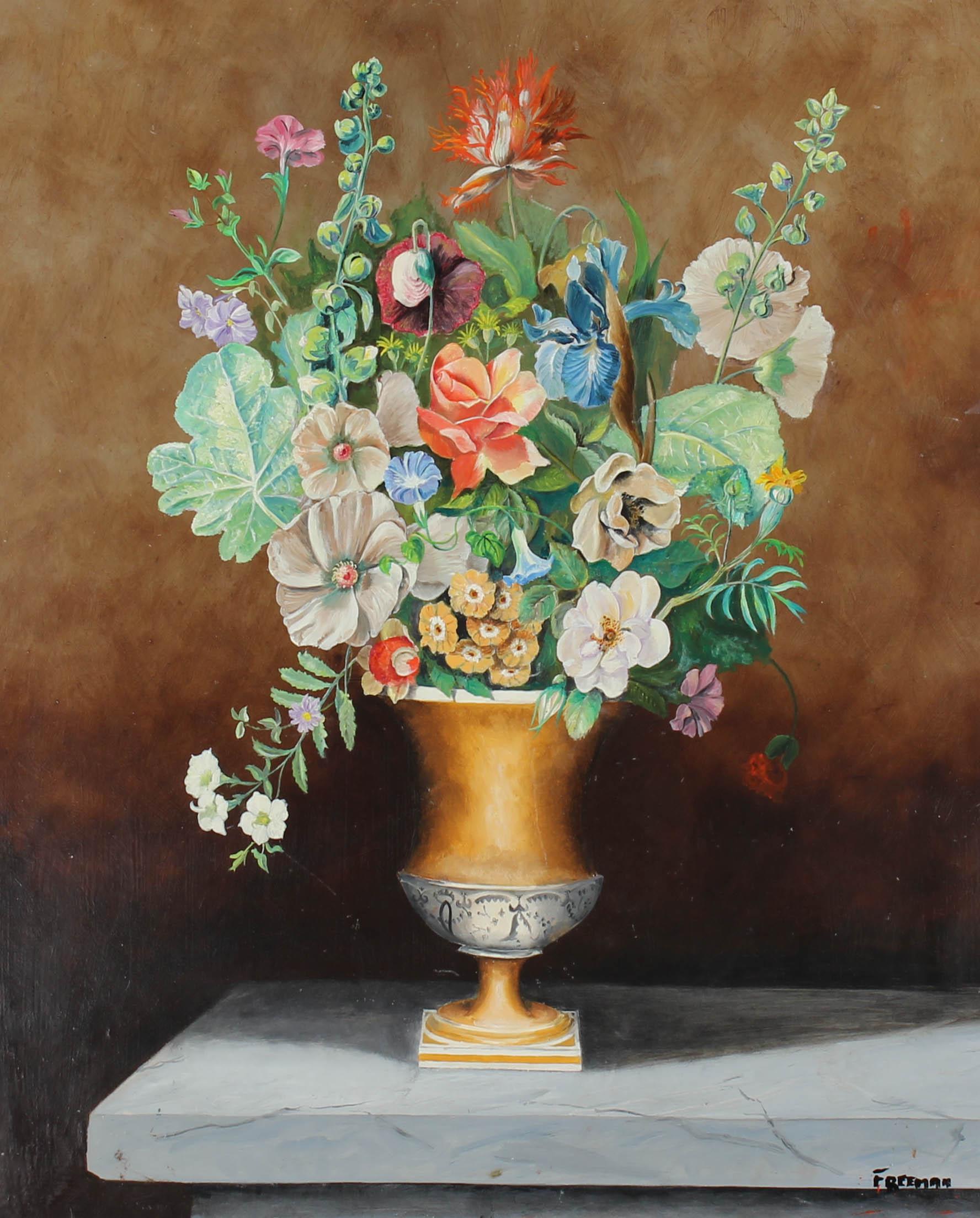 An exuberant multi coloured still life of floral blooms, arranged in a decorative gold lustre urn, positioned on a marble mantlepiece. The painting is signed to the lower right-hand corner. Beautifully presented in a complementing swept rail frame,