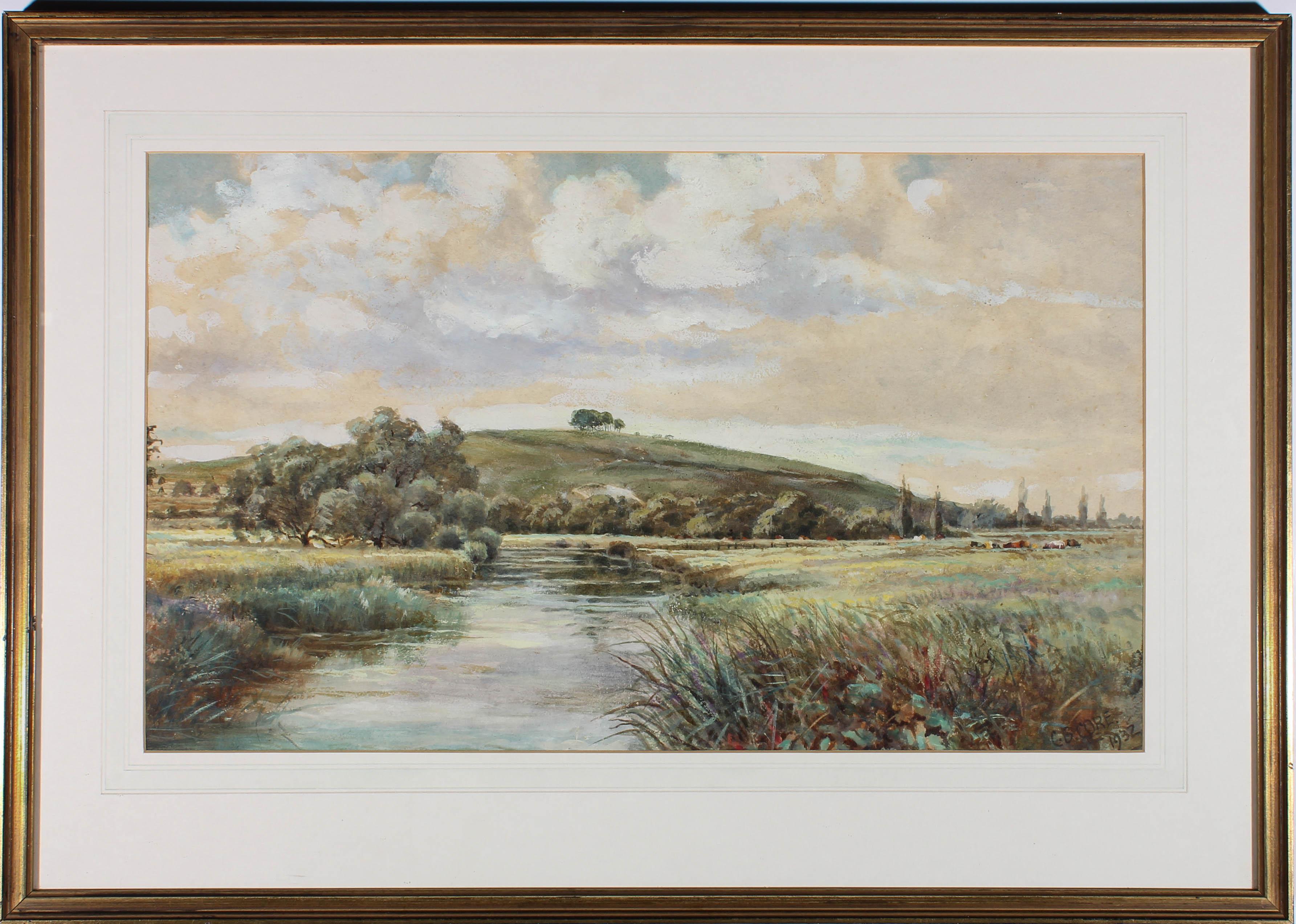 This charming landscape scene depicts a river winding through a meadow where cows are grazing. Painted in fine watercolour detail. Signed and dated to the lower right. Presented in a glazed gilt frame and white card mount. On paper.