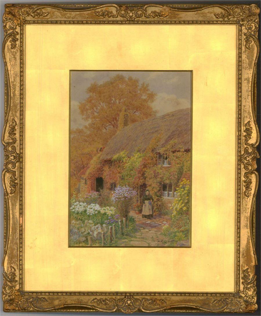A charming early 20th Century watercolour showing a quaint thatched cottage with a pretty garden. An old lady stands in the garden holding a jug. The artist has signed to the lower right corner. The painting has been attractively presented in an
