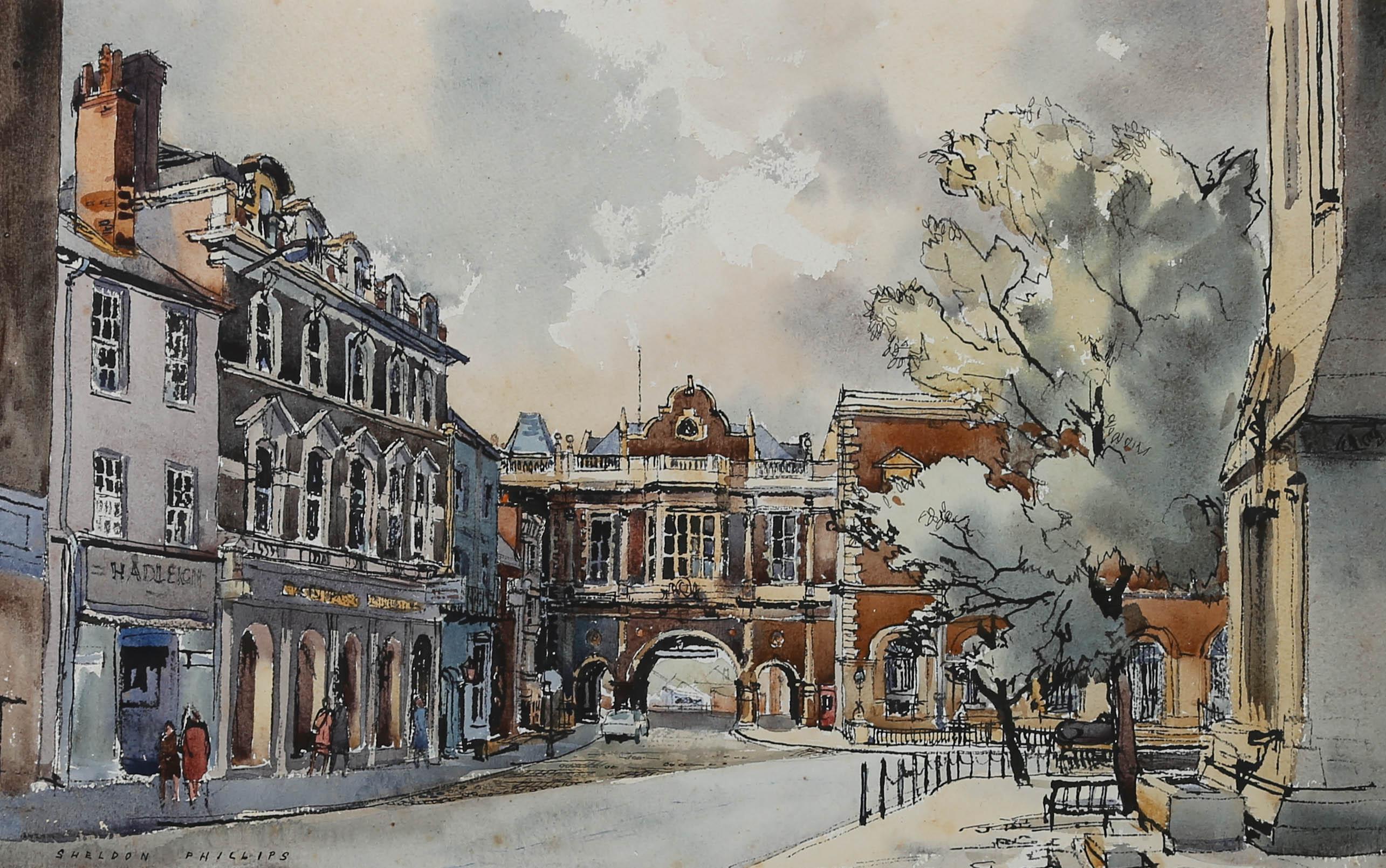A colourful and detailed watercolour composition of a street scene by artist Sheldon Phillips. Figures can be seen window shopping along a picturesque high street. Signed in the watercolour. Presented in a cream mount and glazed gilt effect frame.