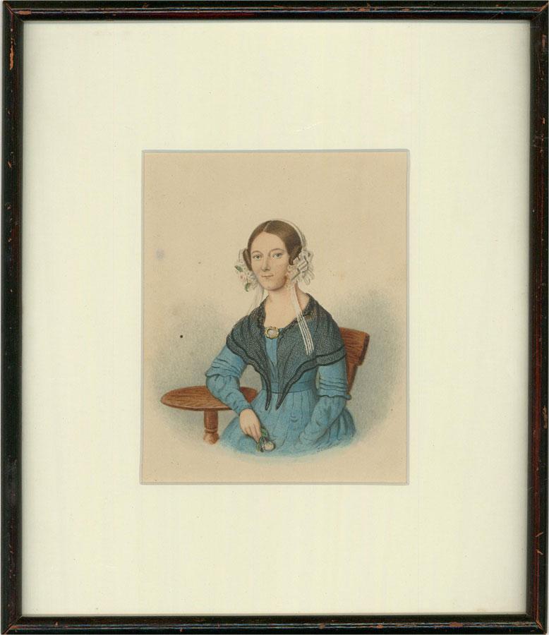 A beautiful 19th century watercolour capturing a young woman in a blue dress holding a single flower. Her intricate lace bonnet is adorned with spring flowers and a large brooch hold a net shawl in place around her shoulders. Painted with intricate