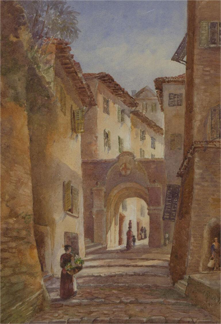 This fine watercolour study depicts a cobbled continental street with figures. The artist captures the narrow street with an expert hand, with a focus on the way that the afternoon light hits the buildings contrasted with deep shadows. Signed and