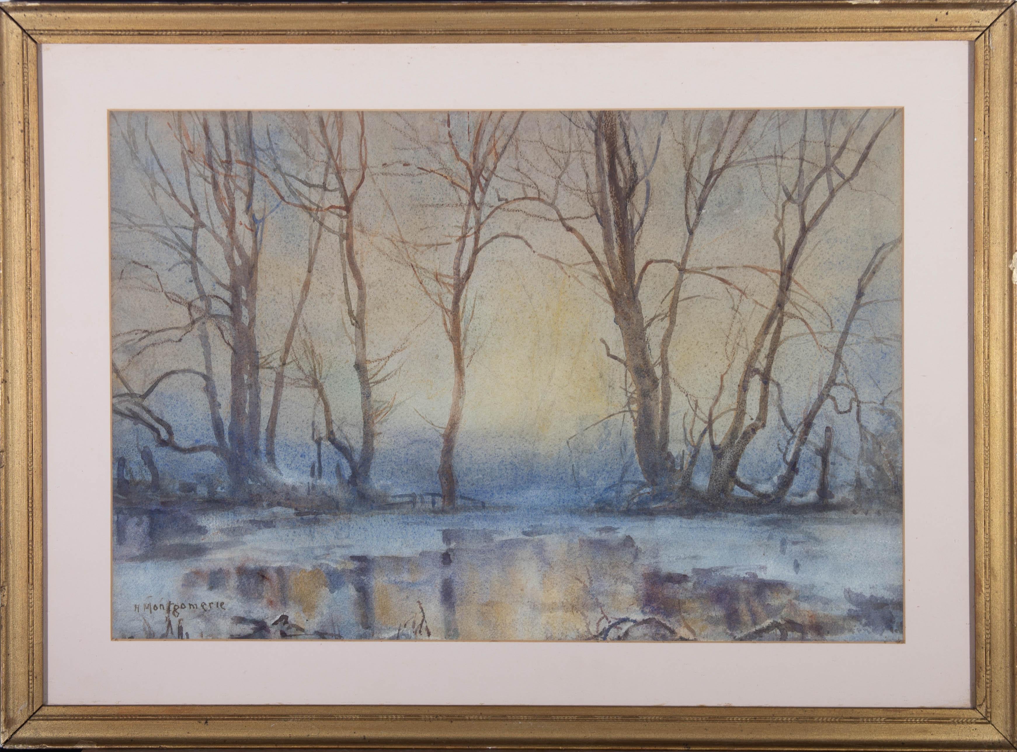 An atmospheric watercolour landscape showing a rural creek frozen over, reflecting the stark trees above and the soft, watery sunset. The artist has signed to the lower left and the painting has been presented in a gilt effect frame with card mount.