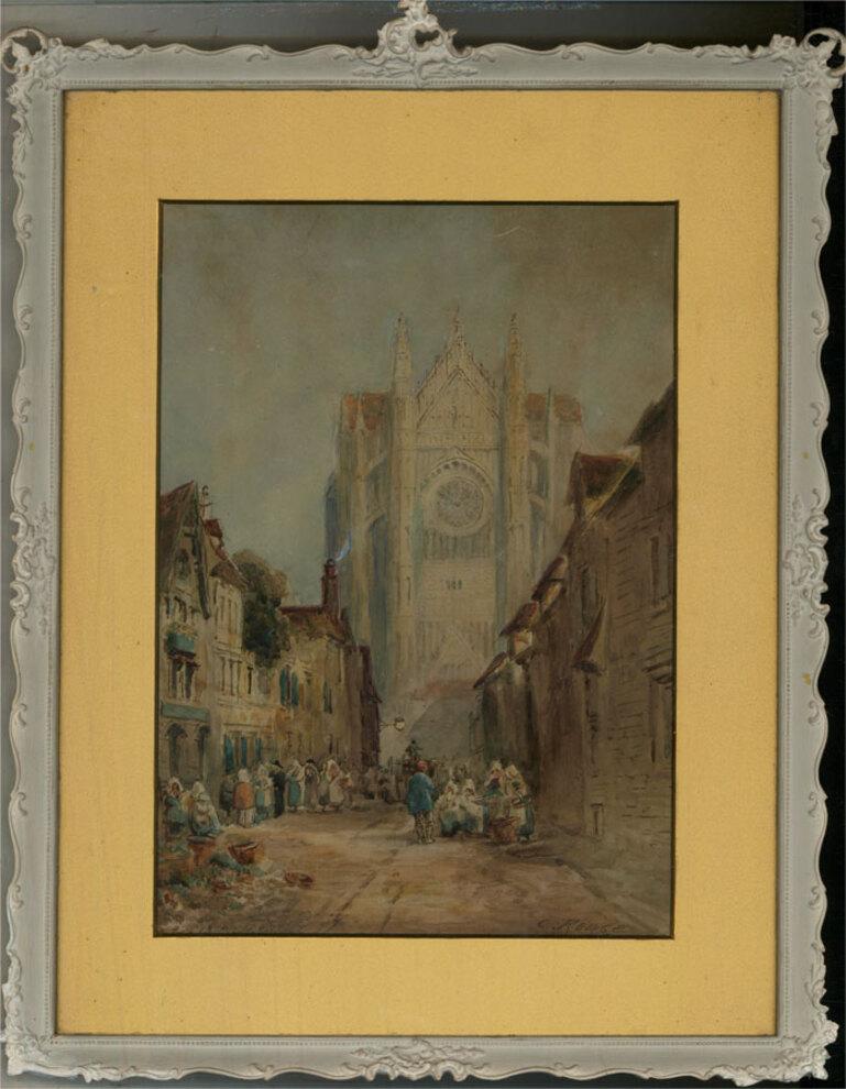 A captivating watercolour painting with gouache details, depicting a busy street scene with a cathedral in the background. Signed to the lower right-hand corner. There is an illegible inscription to the opposite lower corner. Presented in a golden
