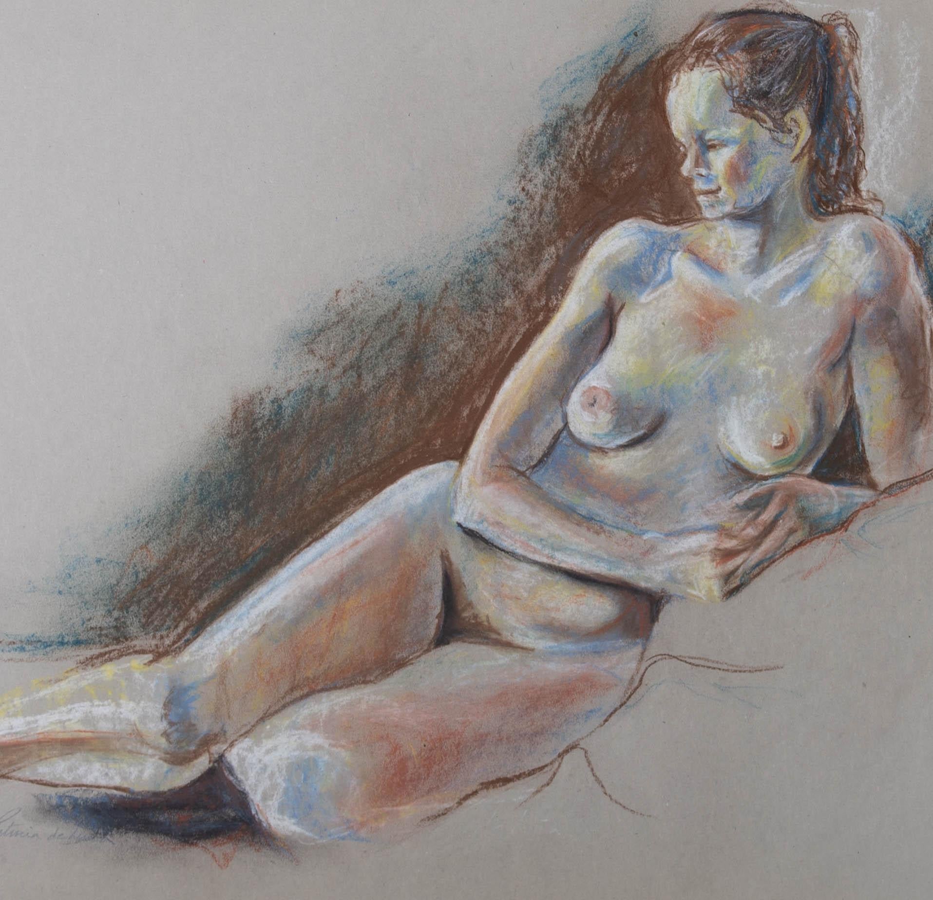 A delightful pastel study of a nude model reclining onto a soft surface. The artist has used shades of blue and red in expressive markings to capture the model's features. Signed to the lower left. Well presented in a card mount. On wove.