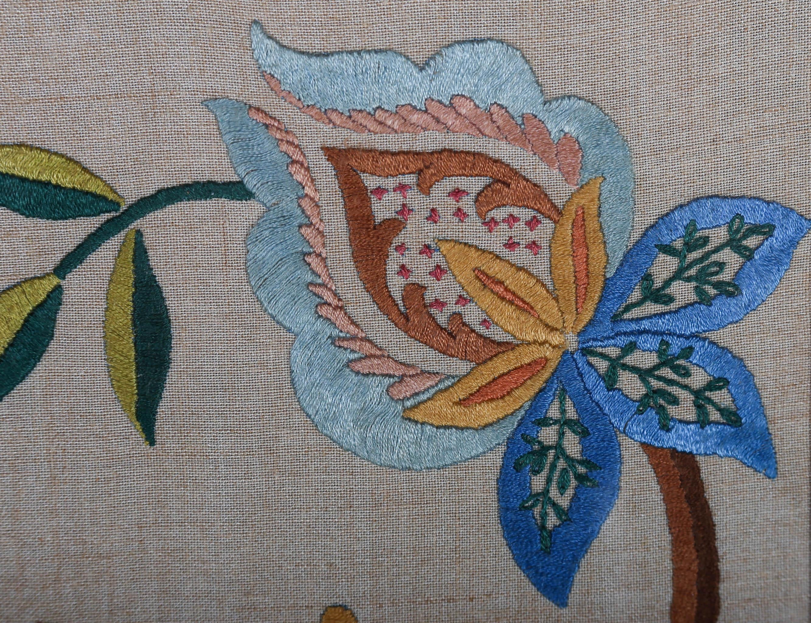 Curvaceous art nouveau flowers have been carefully embroidered with colour threat to complete is lavish botanical motif. A mix of stitching patterns have been used by the artist to bring to life each floral element. Unsigned. The sample has been