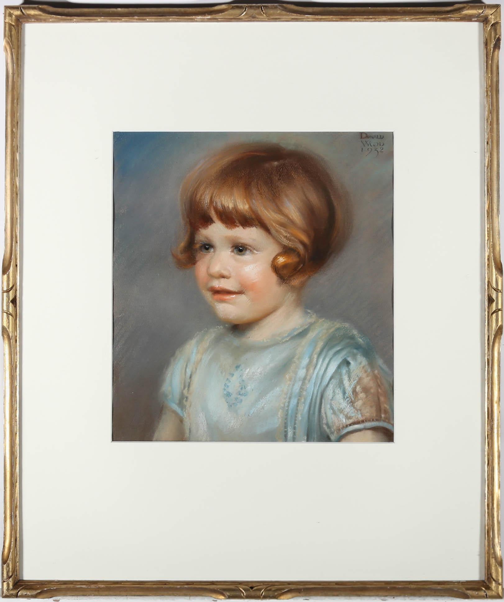 A fine head and shoulders portrait of an innocent young girl, delicately depicted in soft pastel by British artist Donald Wood (1889-1953). The drawing has been carefully signed and dated to the upper right corner. Beautifully mounted in an elegant
