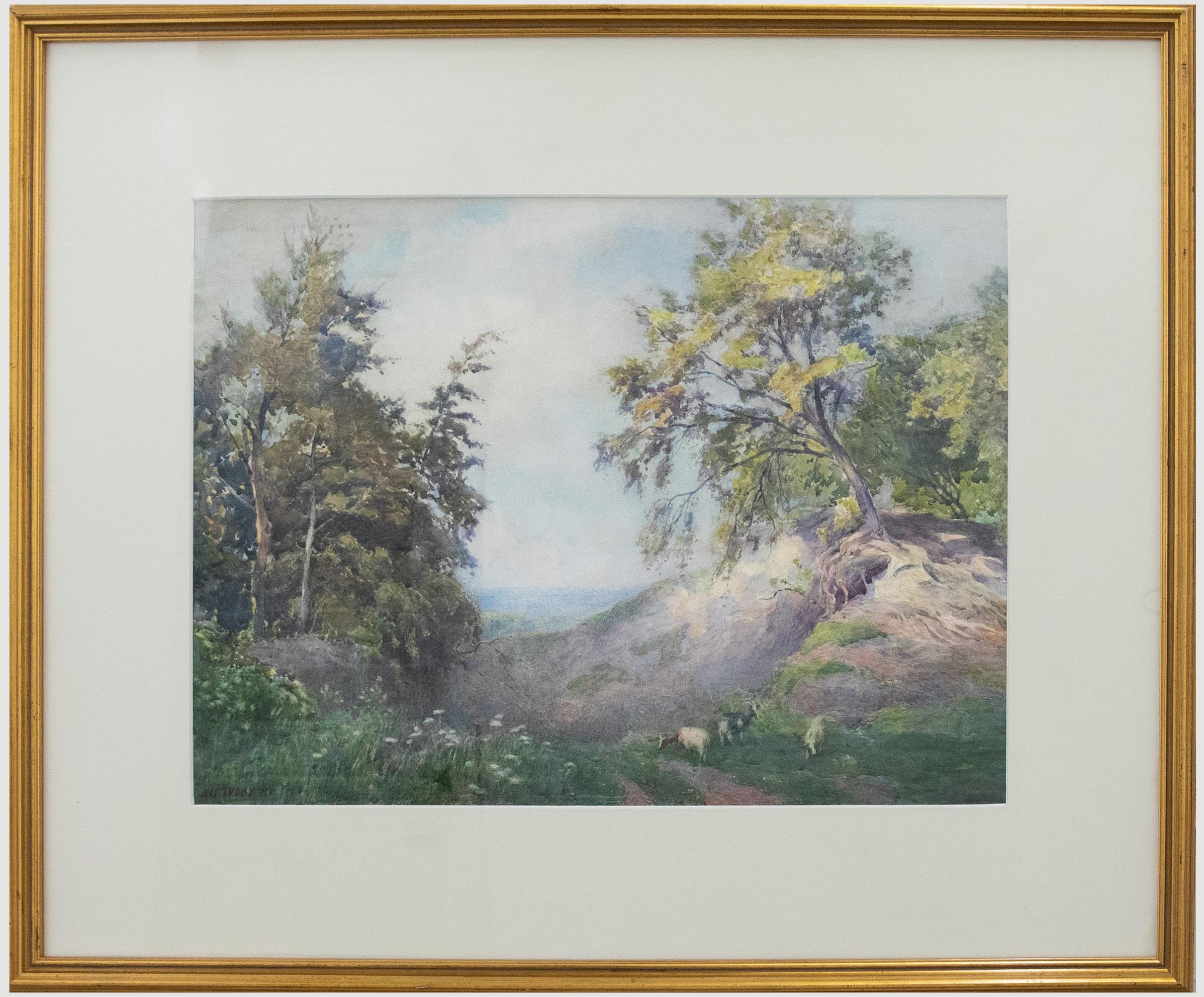 A charming watercolour painting by the artist Max Ludby, depicting a surrey landscape with goats roaming at the edge of a woodland. Well-presented in a white card mount and slim gilt frame. Signed. On watercolour paper. 