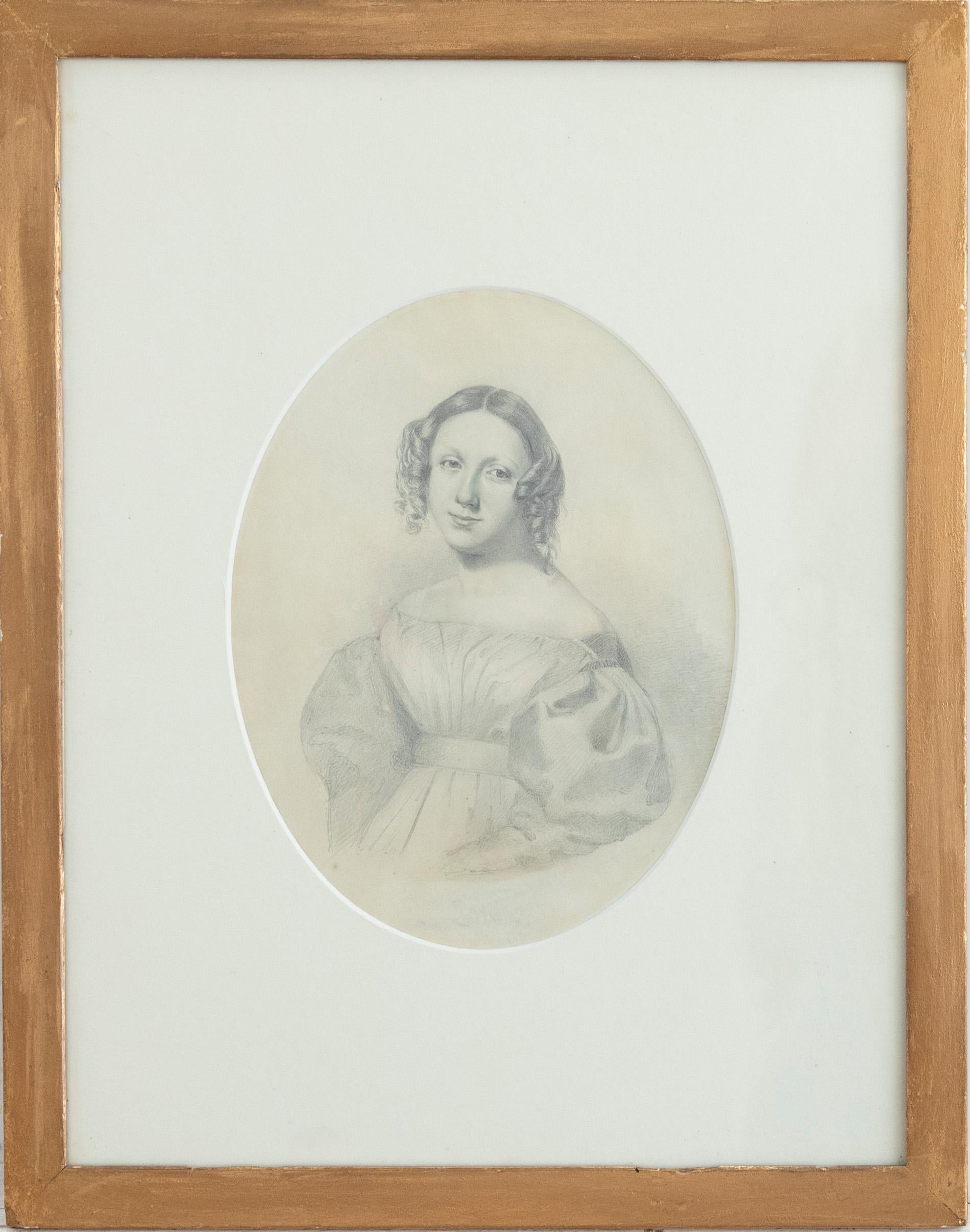 A charming graphite study in the delicate manner. The woman wears a puffed sleeved and ringlets fall to the side of her face in a typical Victorian fashion. Unsigned. Presented in a gilt frame. On paper.