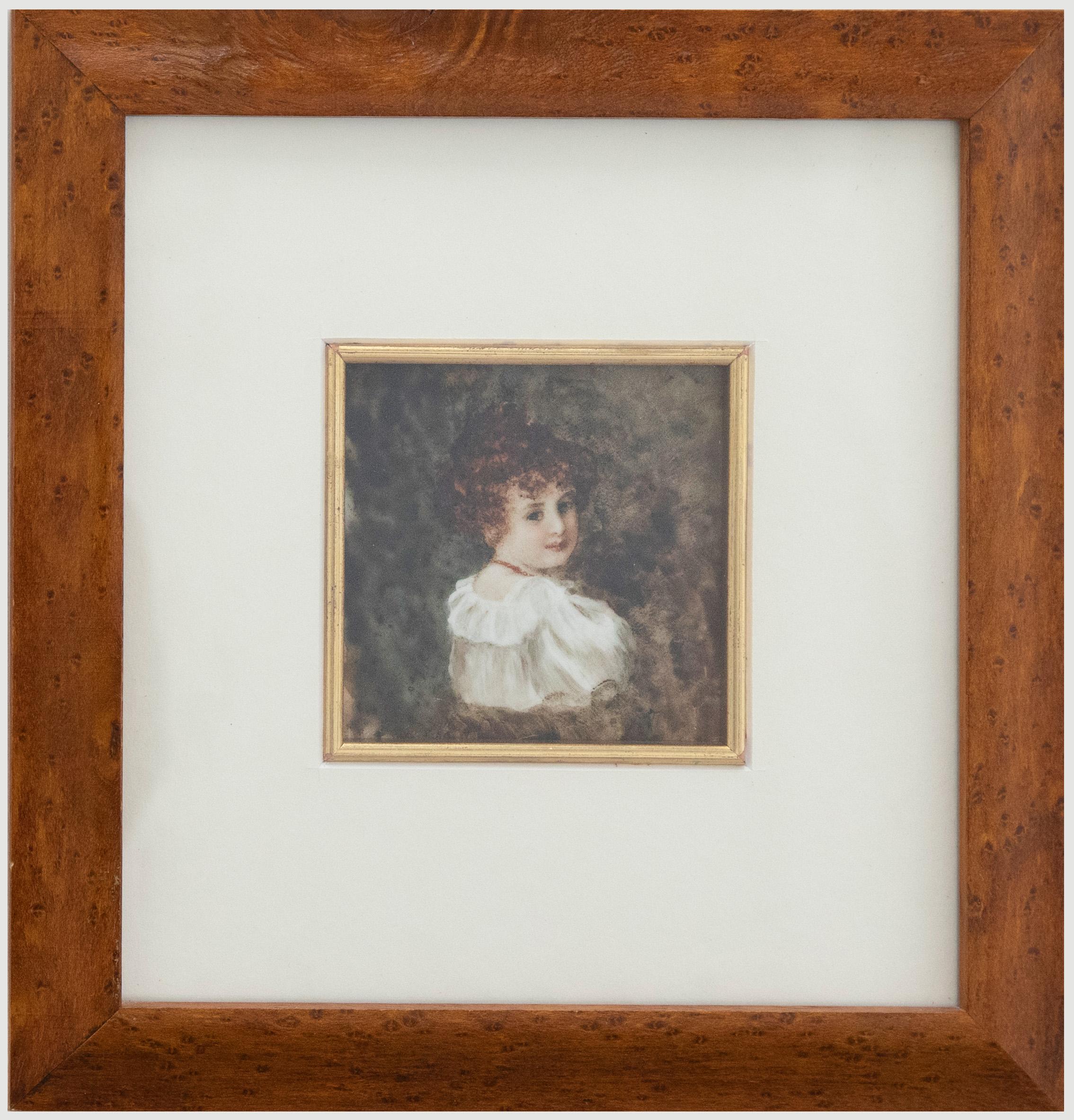 A delicate portrait miniature of a Victorian girl wearing a puffed blouse and beaded red necklace. The girl stands with her back to the viewer, peering over her right-hand shoulder. Well-presented in a fine burr wood frame with a square gilt window