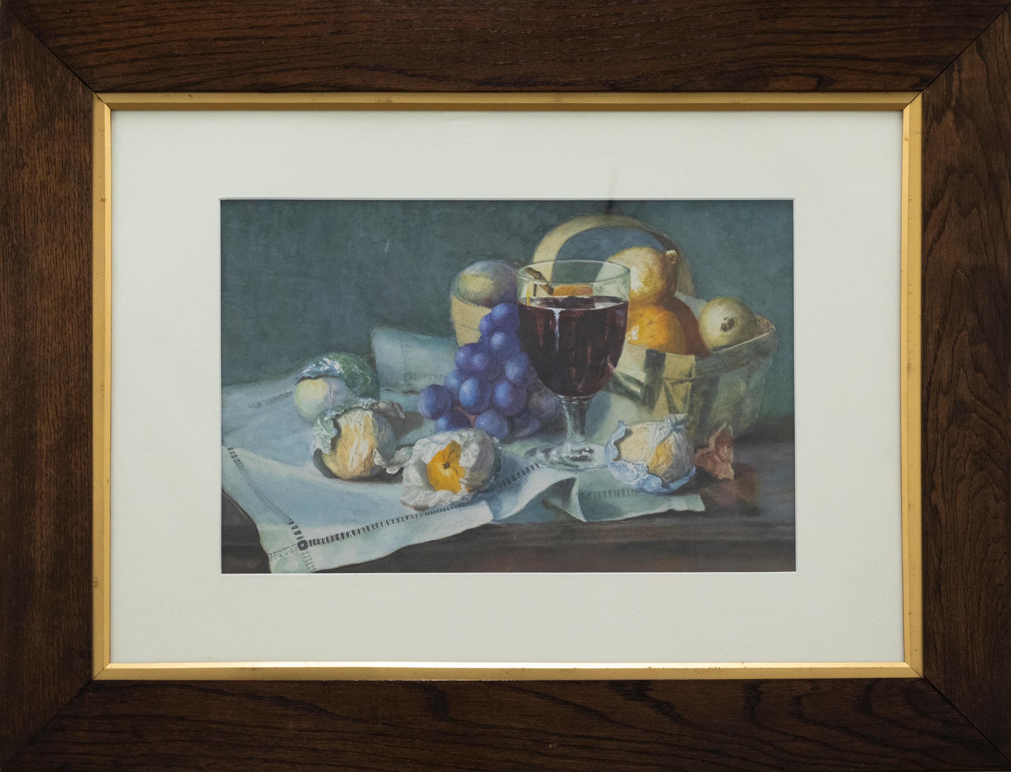 A charming still life study depicting a glass of wine surrounded with half wrapped fruit and a small picnic basket.. Unsigned. Presented in a wooden frame with a gilt slip. On paper.