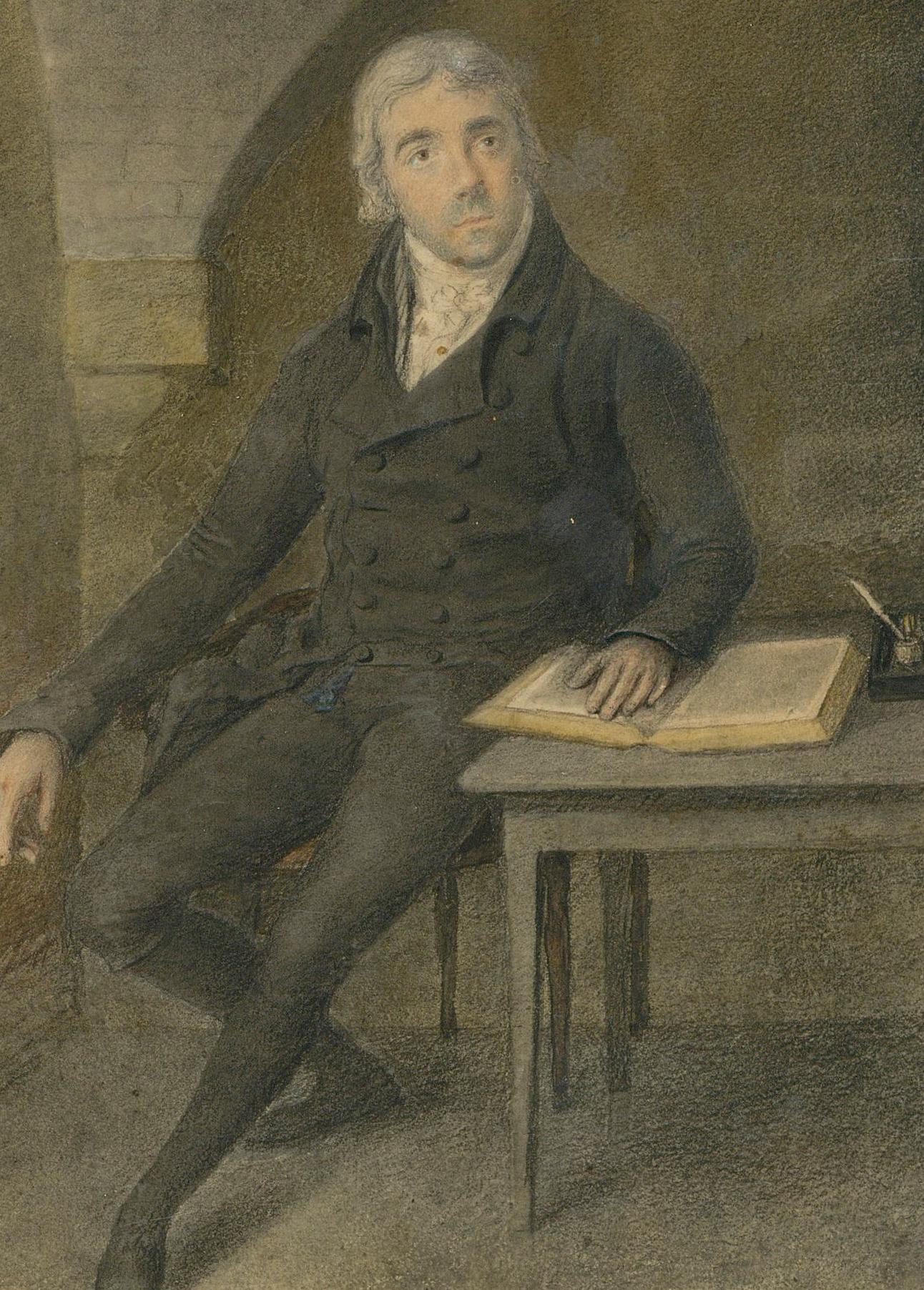A detailed graphite and watercolour portrait of a 19th century gentleman, seated at a writing desk with an open book and inkwell. The gentleman can be seen wearing a black tailored suit, with double buttoned jacket and white neckerchief.