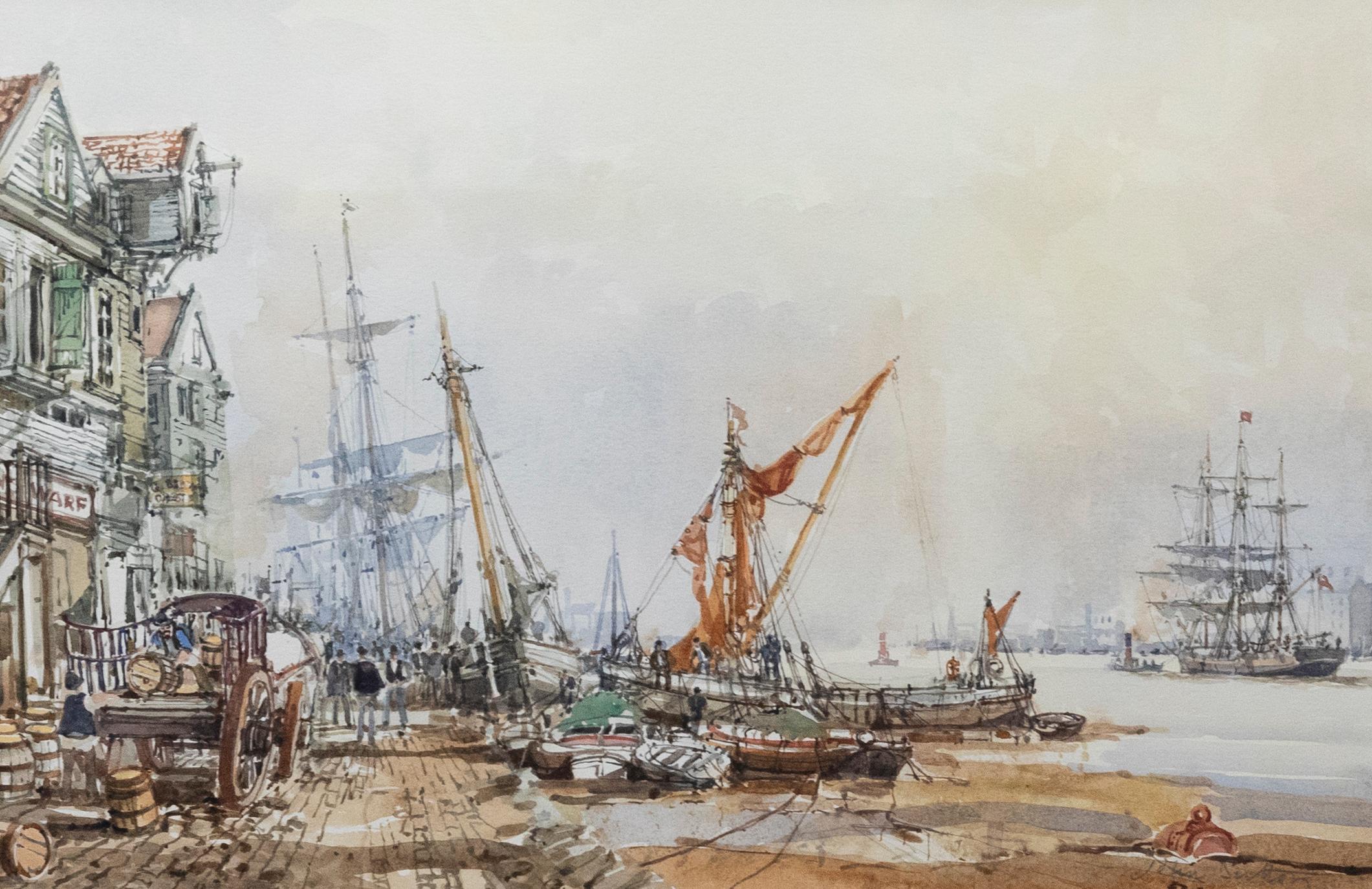 A dramatic harbour scene by the British marine and landscape artist John Sutton. Many hands can be seen along the cobbled sidewalk, loading and unloading a multitude of ships at low tide. The artist has signed in pencil to the lower right and the