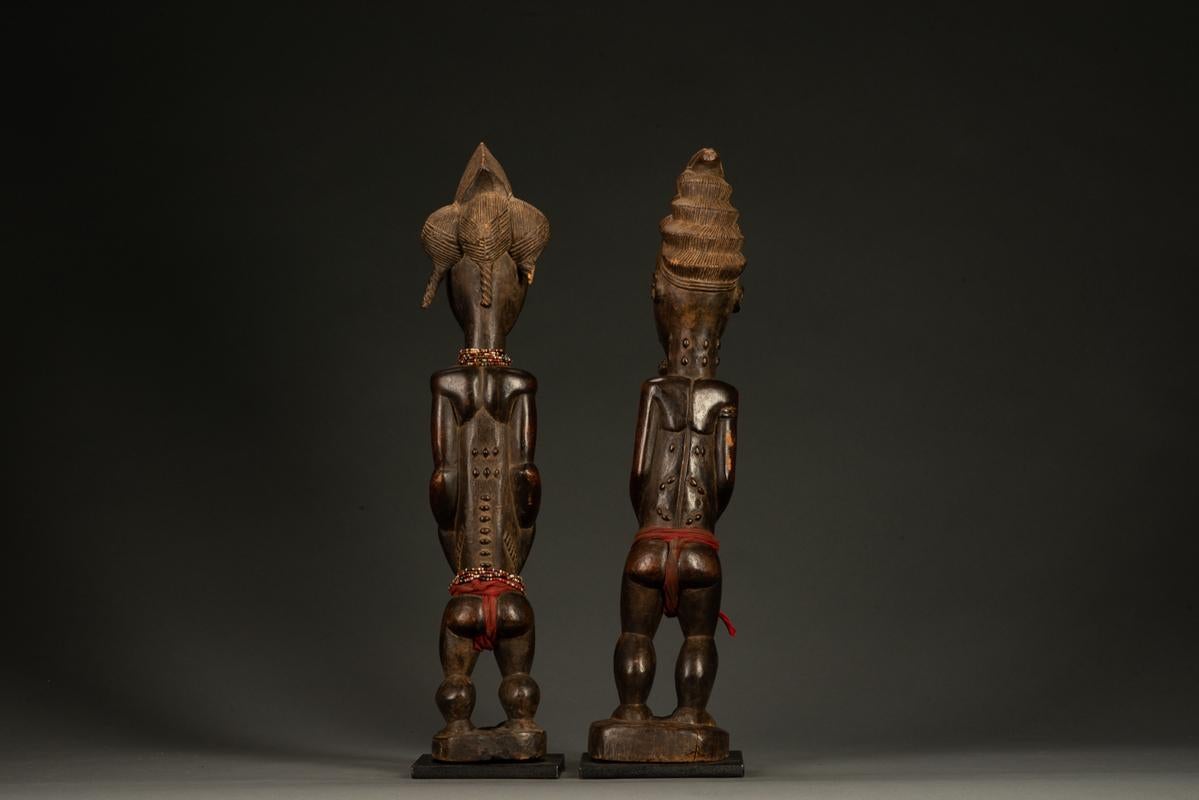 Tribes Baule Male & Female Figures in Wood & Fabric

Côte d'Ivoire (Ivory Coast) 20th Century wood, fabric & beads Male: 19 inches Female: 19 inches

Each piece of tribal art is hand carved, passed down from generation to generation, and is an