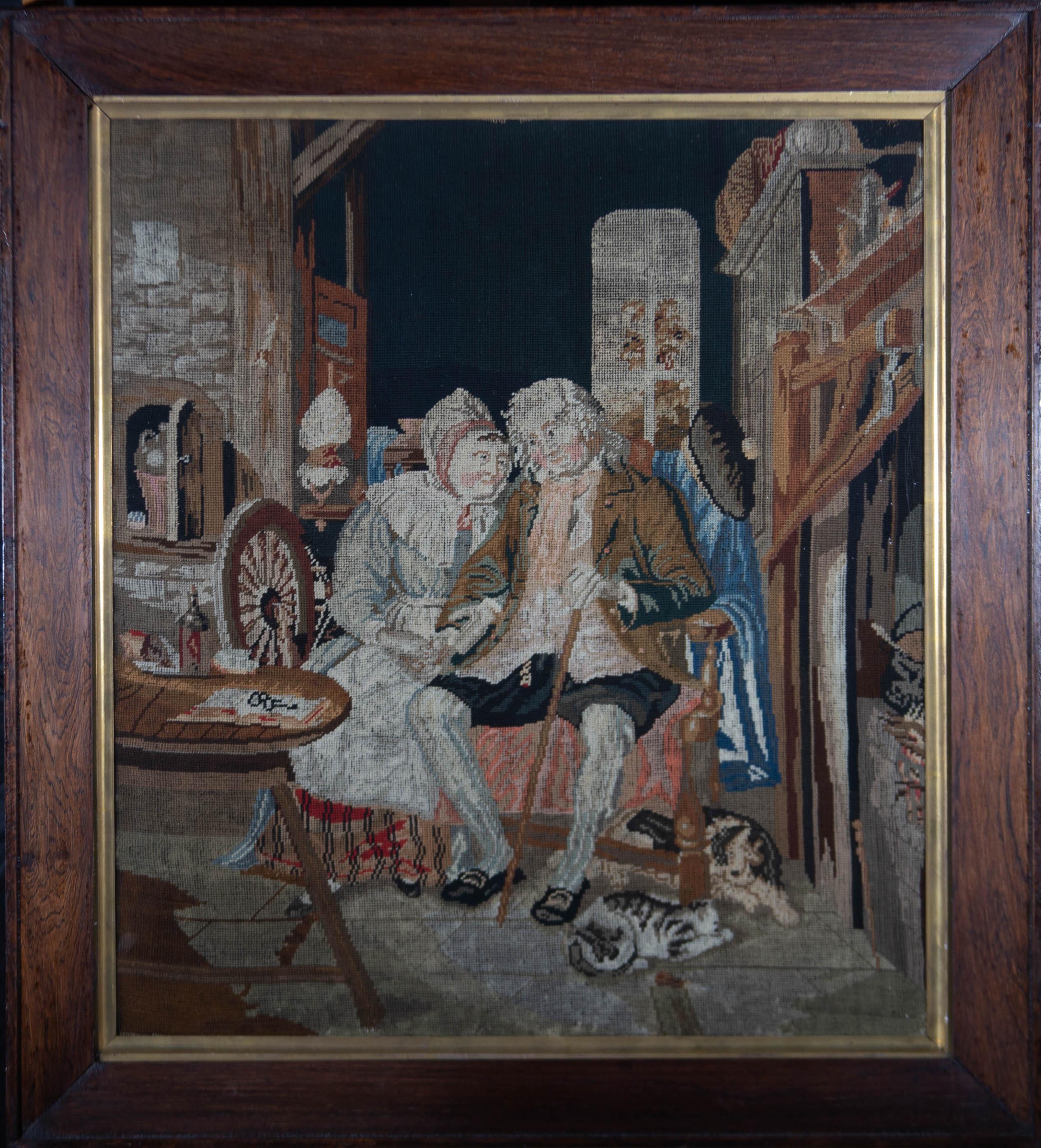 A charming petit point needlework from the late 19th Century, showing a heartwarming scene of an elderly couple sitting in a close embrace in their home with the cat and dog at their feet. The needlework is presented in a yew wood frame with