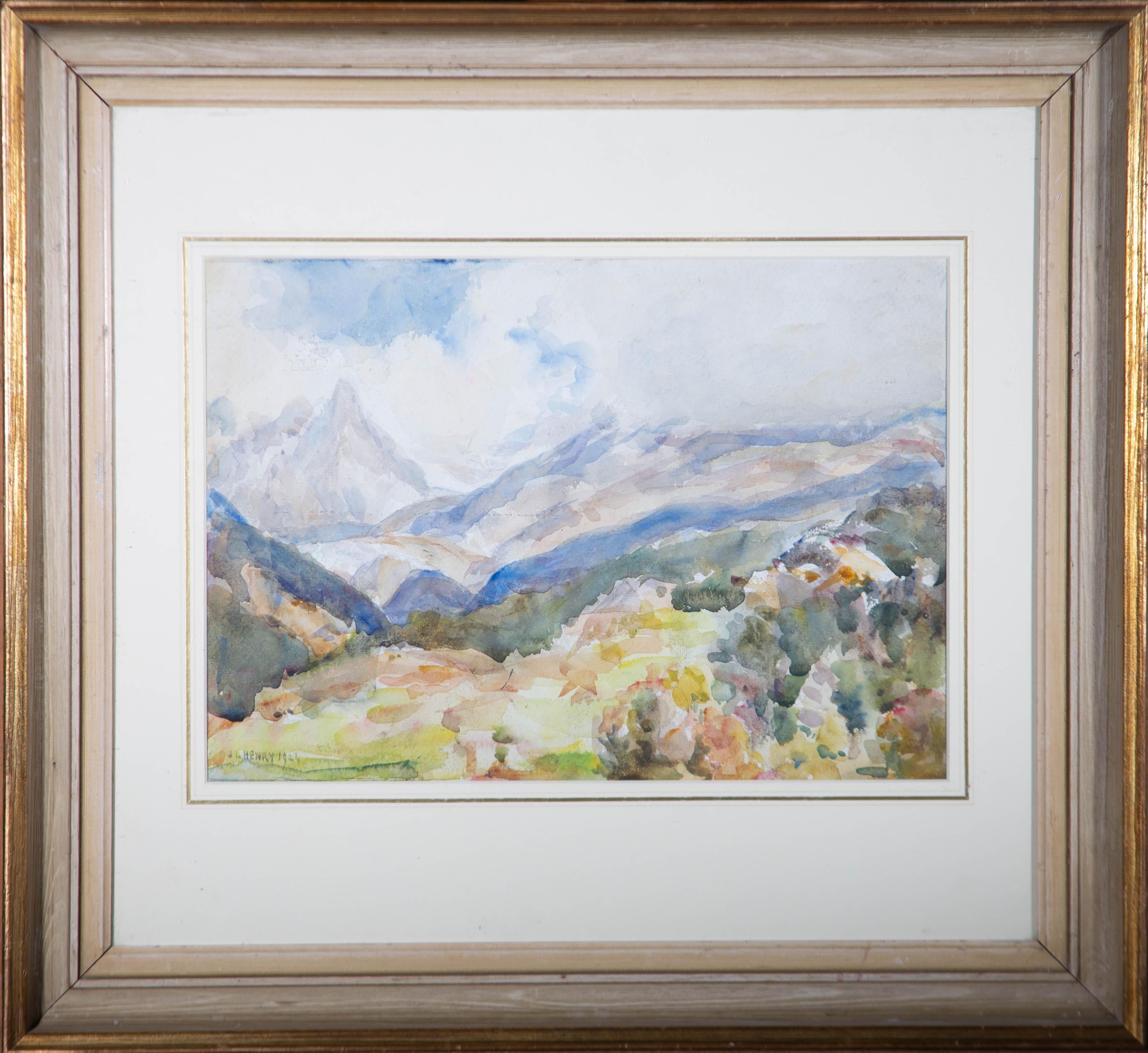 An attractive watercolour painting by the artist James Levin Henry, depicting a mountainous landscape view. Signed and dated to the lower left-hand corner. Presented in a washline card mount and in a distressed, gilt effect wooden frame. On