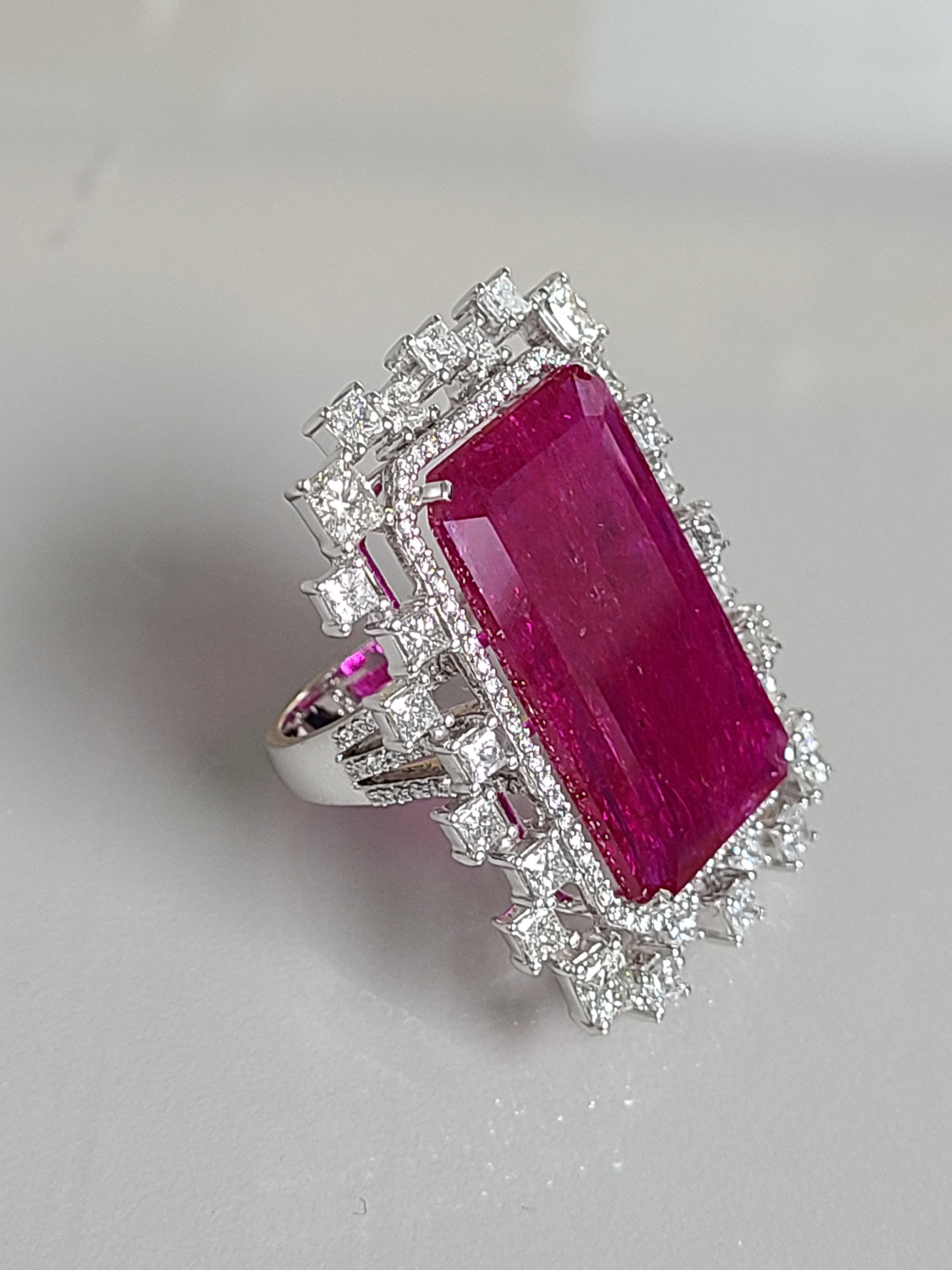 A beautiful and rare Big Mozambique un-heat ruby set in 18k white gold with diamonds . The ruby weight is 22.57 carats and is rare to find this size pieces . The diamond weight is 3.30 carats . The ring dimensions in cm 3.5 x 2.5 x 2.5 (L X W X H).