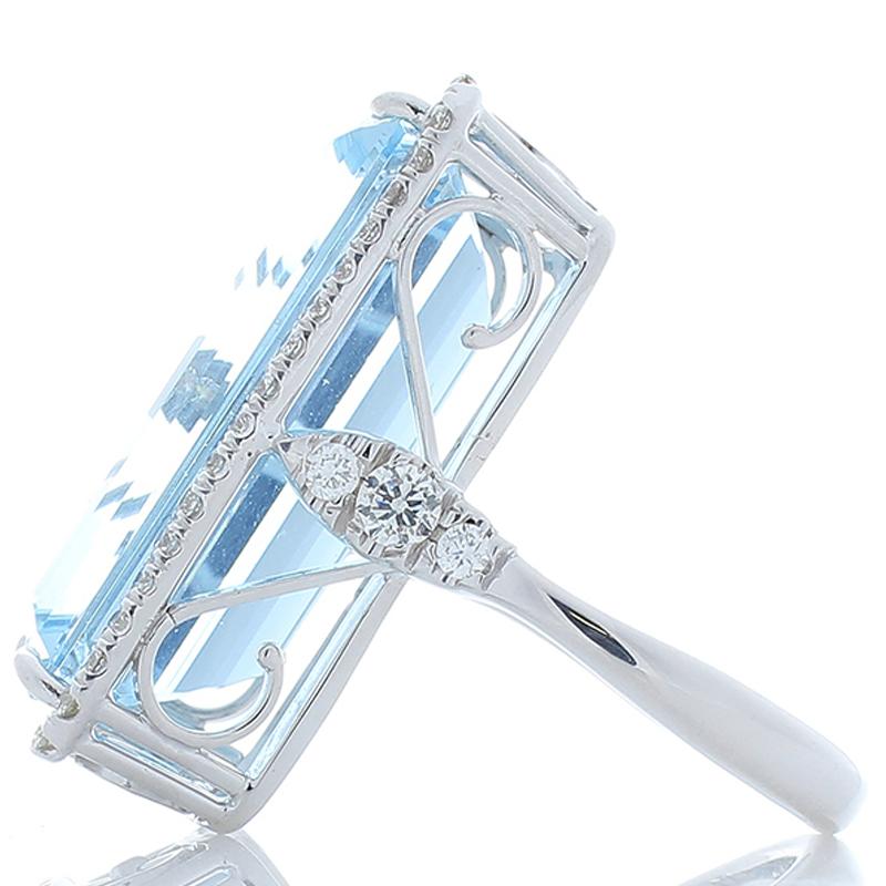 This ring is bold, and it is stunning! The ring features a stately 22.59 carat emerald cut aquamarine that is accented by glittering bright white diamonds that total 1.03 carat. Its color is most-prized, it's what you want. Its origin is from