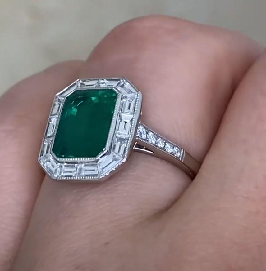 This exquisite ring showcases a stunning approx. 2.20-carat emerald-cut Zambian emerald, renowned for its rich green hue and exceptional clarity. The centerpiece is securely bezel-set, accentuating its natural beauty while ensuring durability.