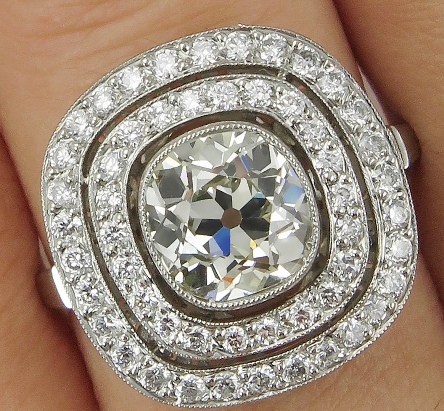This breathtakingly beautiful and Delicate Antique Vintage Cushion shaped Platinum Ring (stamped), the Center Diamond is an OLD Mine Cut estimated 1.66CT in K-L color, SI3 clarity ( Appears Warm White and eye clear), EGL USA Certified.
It is