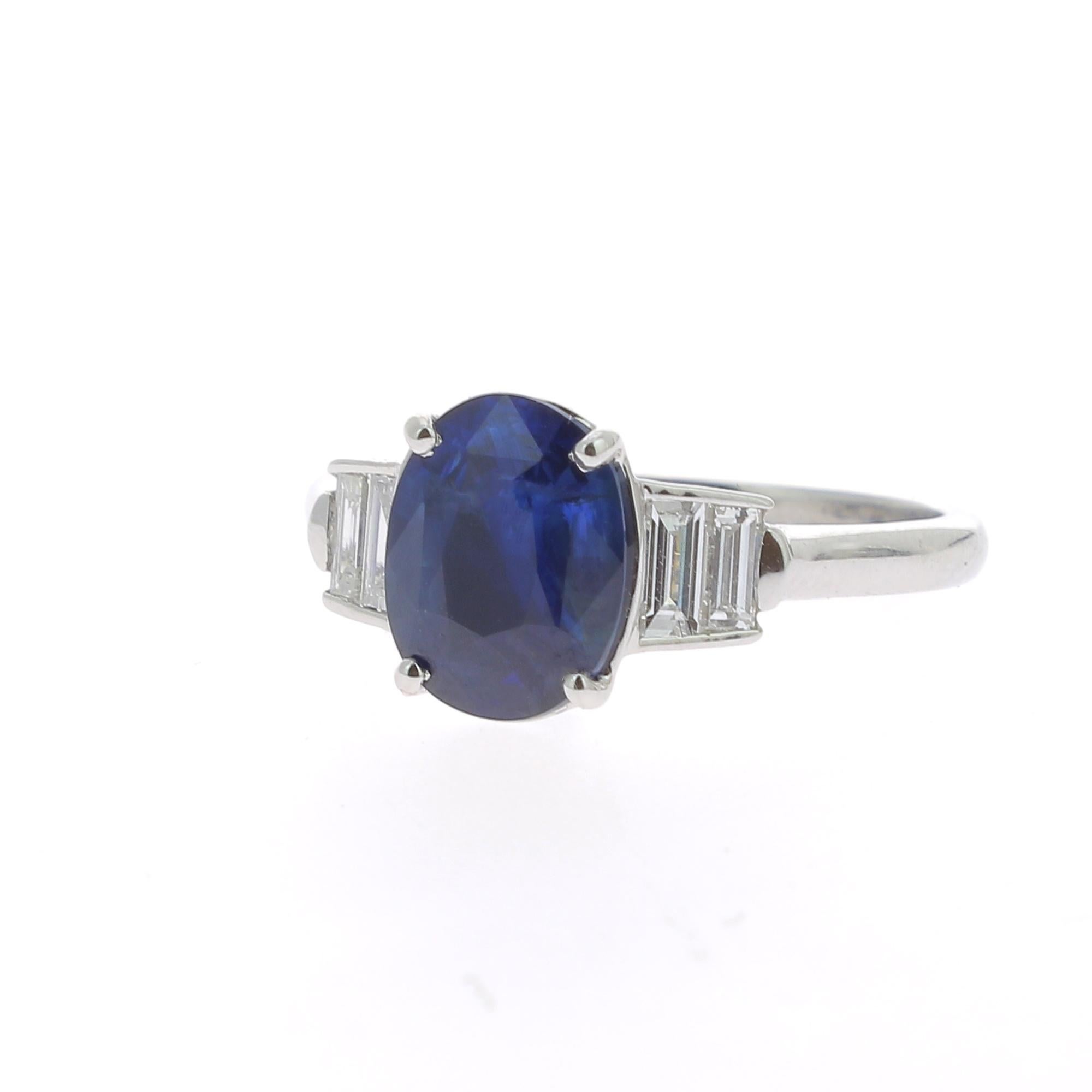 An amazing Blue Sapphire Ring flanked on each side by a 2 Baguette Diamonds.
The total weight of the Sapphire is 2.26 Carats, the gemstone is certified as a Blue Sapphire. 
The Baguette Diamond weight is 0.28 Carats ( 4 Baguettes-cut-Diamonds) 
The