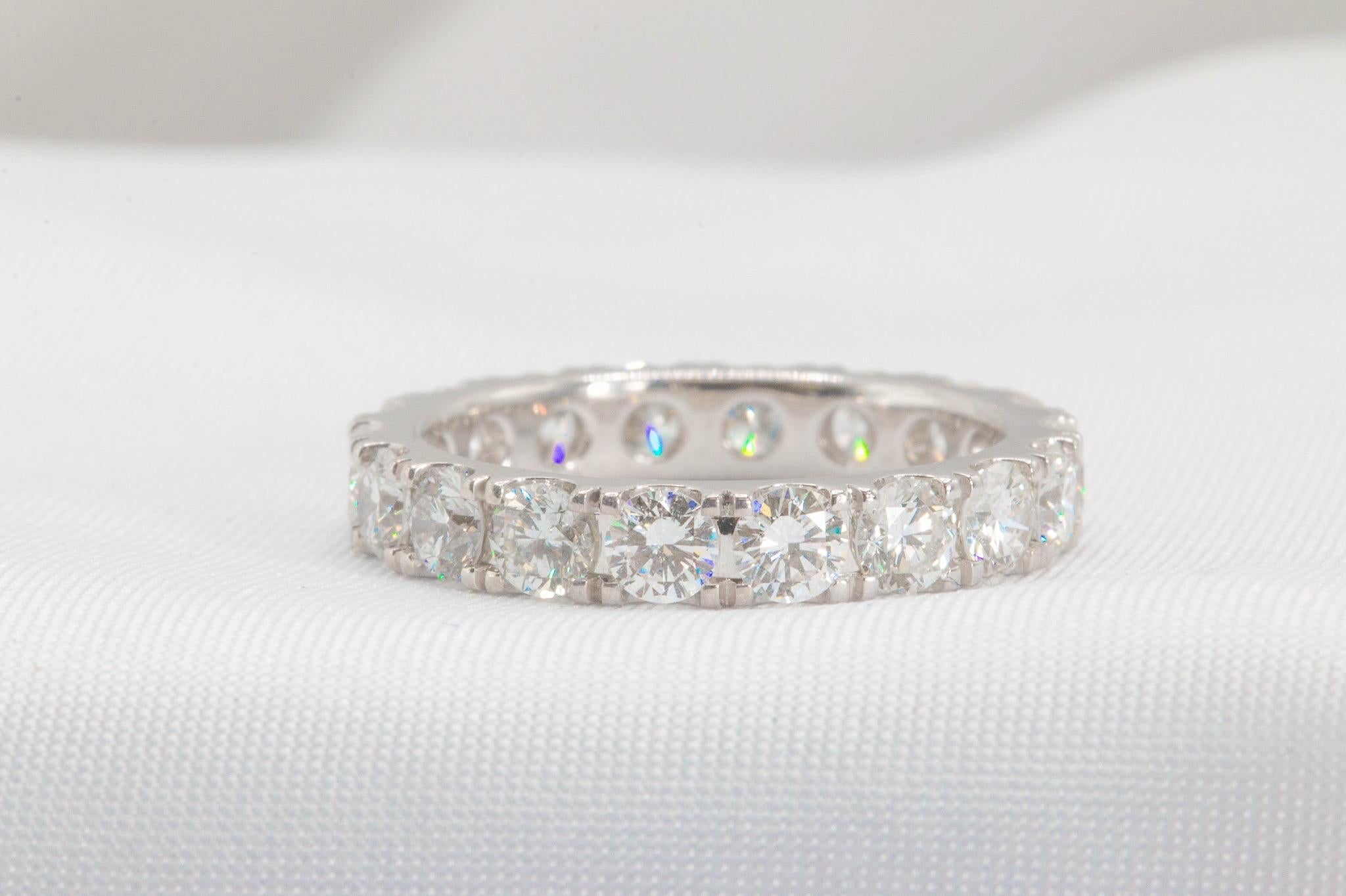 This stunning 2.26-carat eternity band is crafted with 18 high-quality natural diamonds, each weighing approximately 0.125 (1/8th) carats. Graded G-H in color and VS1-VS2 in clarity, these round brilliant diamonds create an unbroken halo of glitter