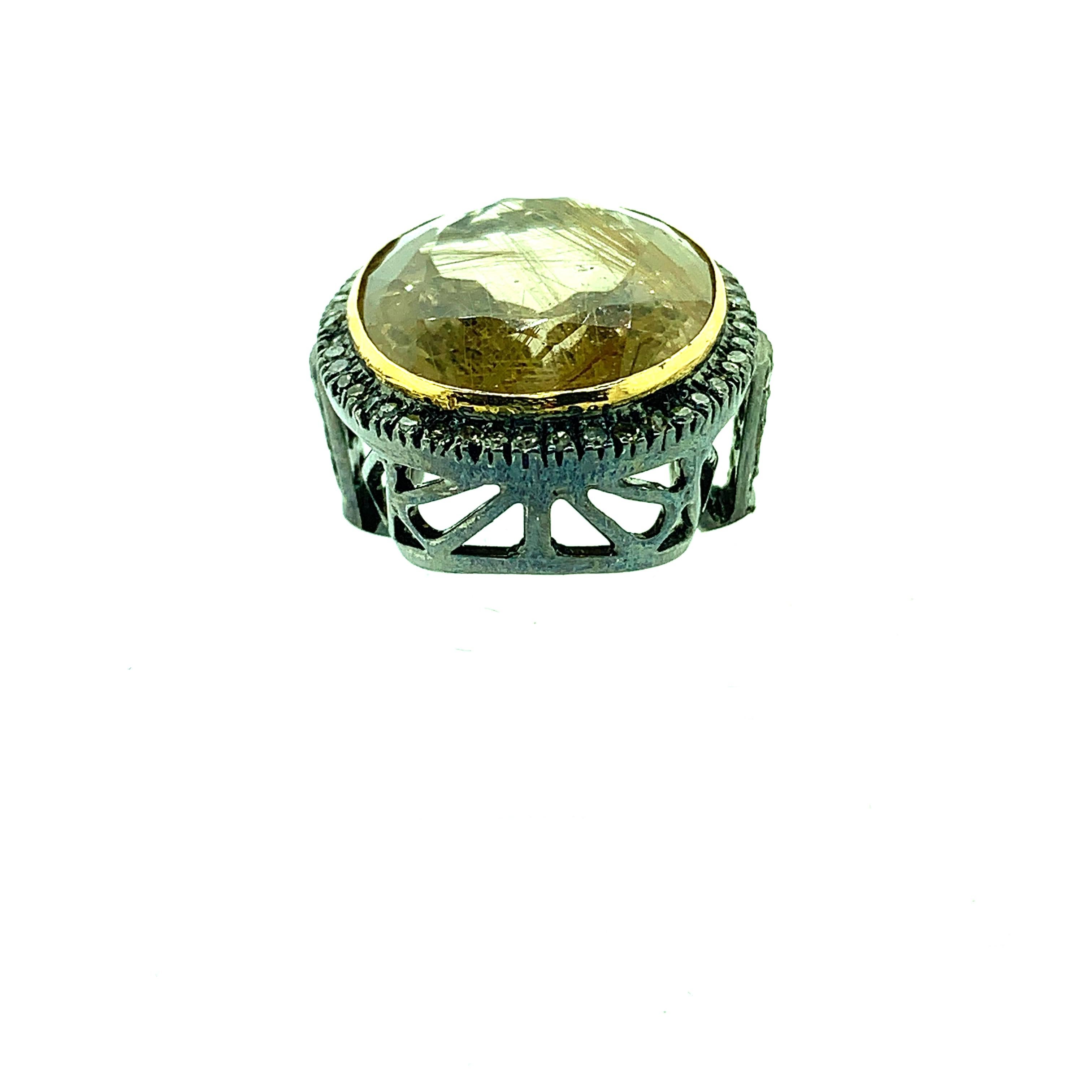 The gemstone is 100% natural with golden needles. A rare find! this ring is made with oxidize silver and 14K gold which complements the golden needles perfectly. Rutilated quartz is sorrouned by chapagne diamonds gives luxurious look. This is one of