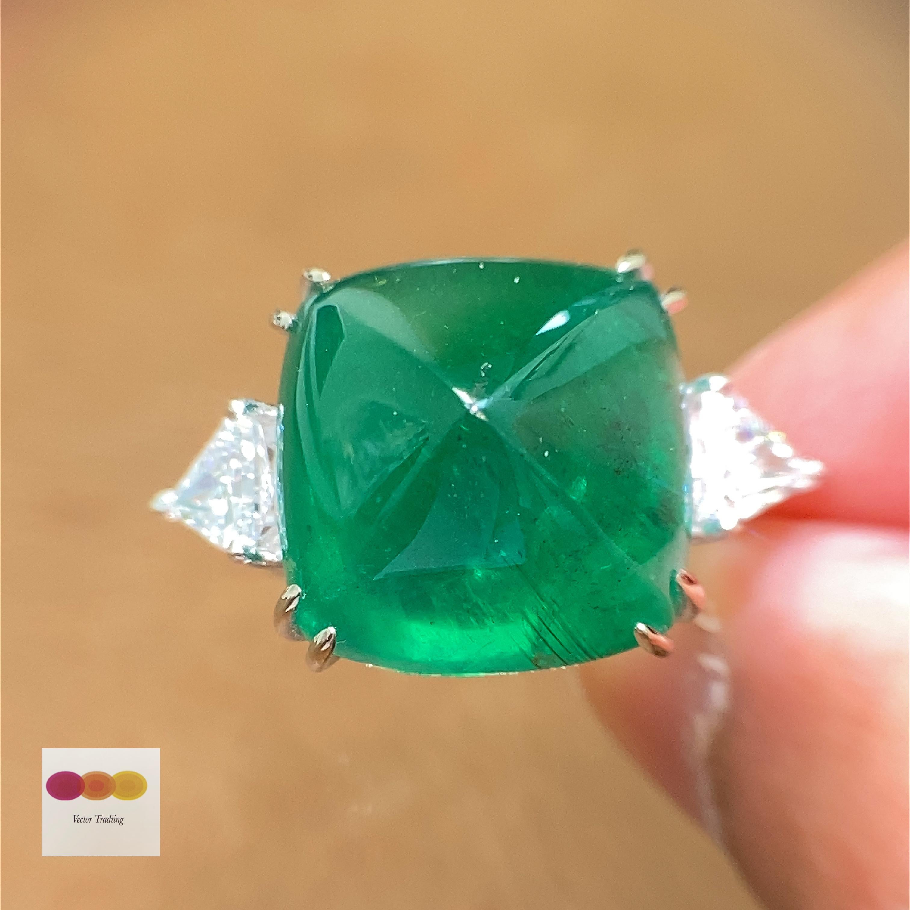 22.61 Carat GRS Certified Emerald Sugarloaf and White Diamond Cocktail Ring:

A gorgeous ring, it features a luscious emerald sugarloaf weighing 22.61 carat flanked by two shield-cut white diamonds weighing 1.02 carat. The emerald sugarloaf,