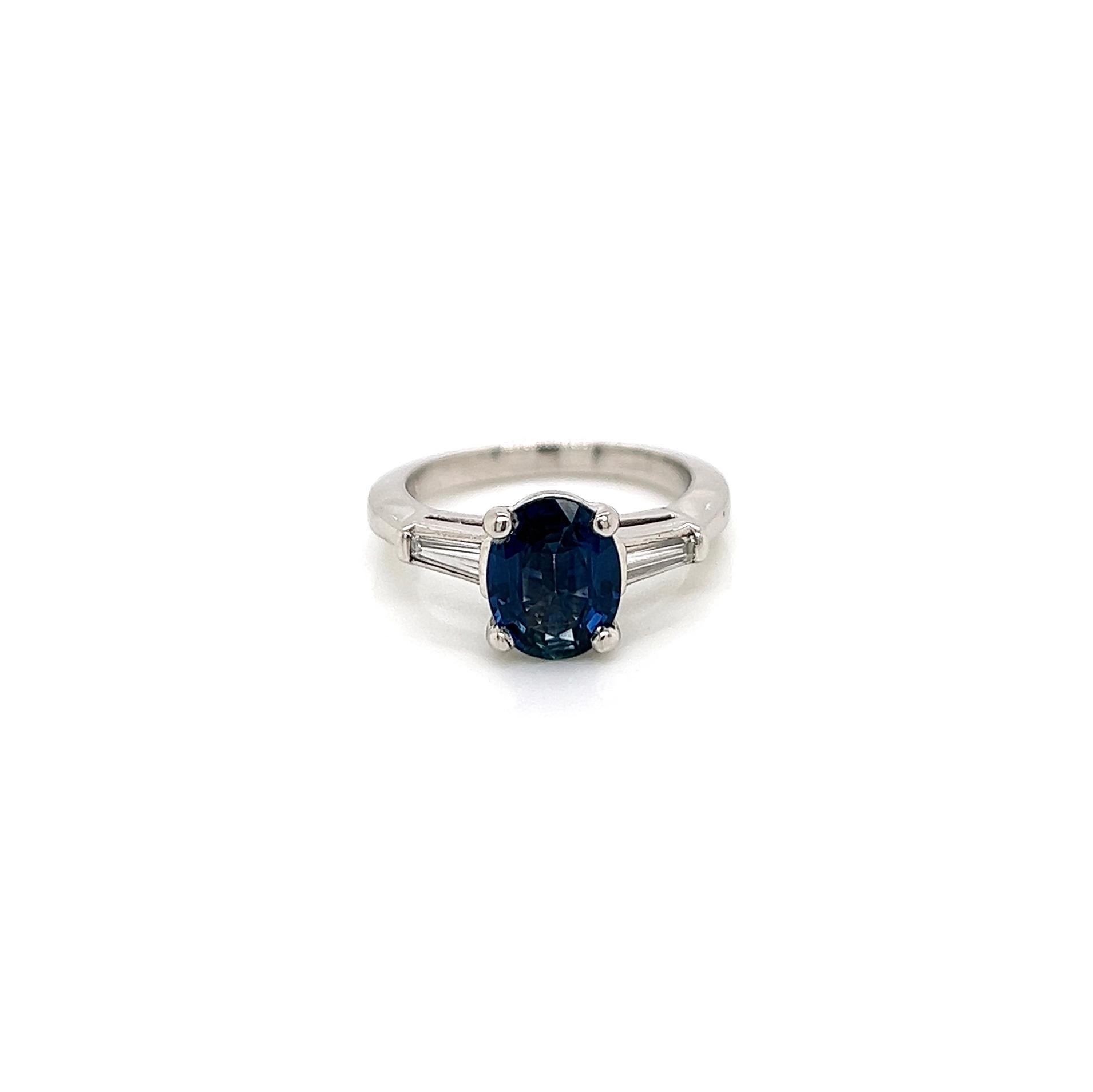 2.26 Total Carat Sapphire Diamond Engagement Ring

-Metal Type: Platinum
-1.96 Carat Oval Cut Blue Sapphire, GIA Certified 
-0.30 Carat Baguette Side Diamonds 
-Size 5.5

Made in New York City