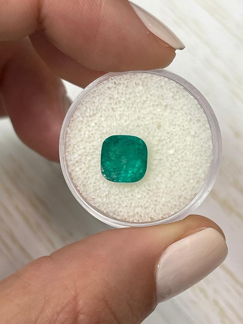 Stone: Emerald
Weight: 2.27-carats
Shape: Cushion Cut
Clarity: Semi-Transparent, Visibly Imperfect
Luster: Good
Color: Medium Green
Measurements: 8.49mm x 8.34mm x 6.0mm
Geographic Origin: Colombia
Treatment: Natural, Oiling

Comments: Due to their