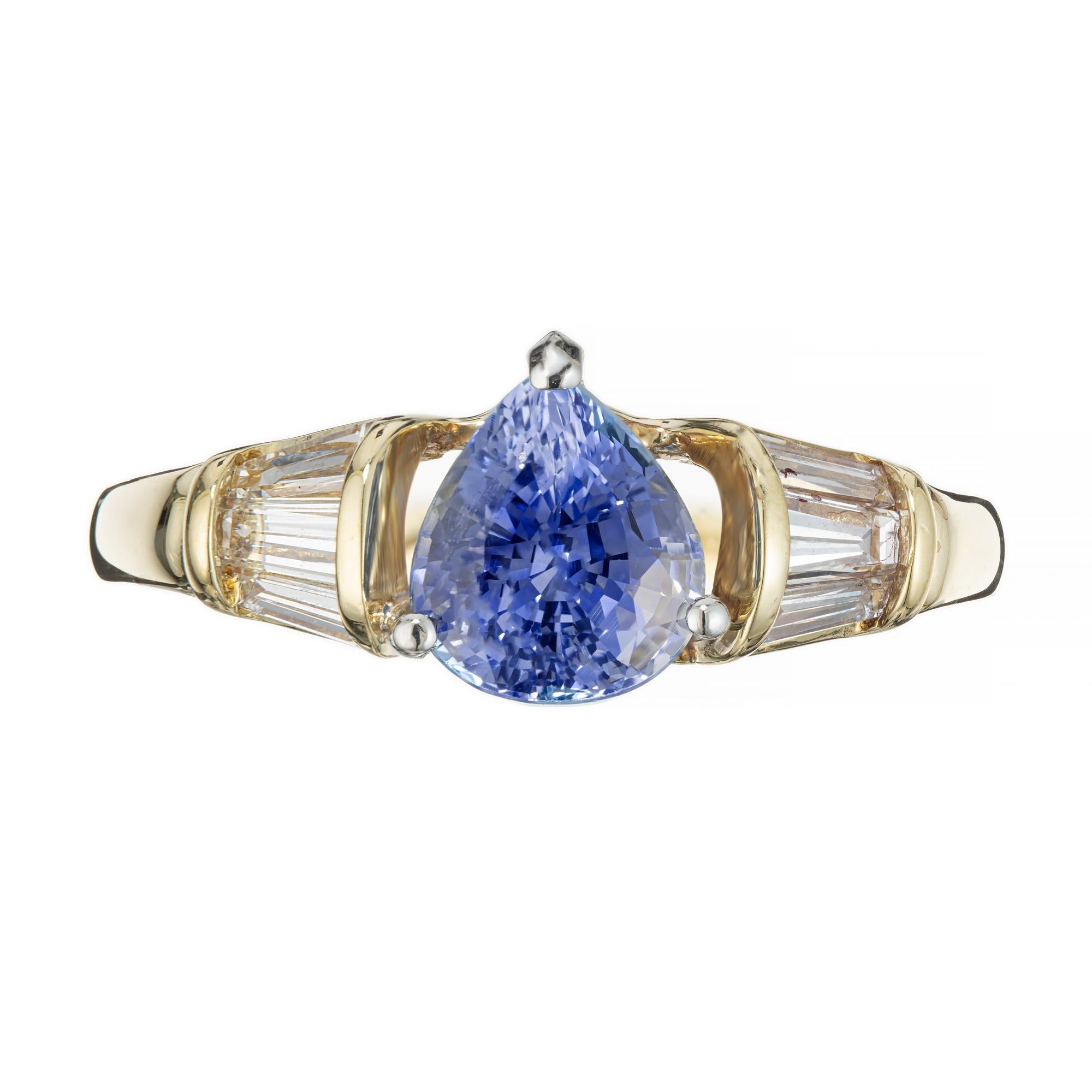 Pear shaped Periwinkle Sapphire and diamond engagement ring. AGL certified pear shaped sapphire mounted in a Platinum and 18k yellow gold setting. Accented with 6 tapered baguette side diamonds. The setting is 18k yellow gold while the crown and