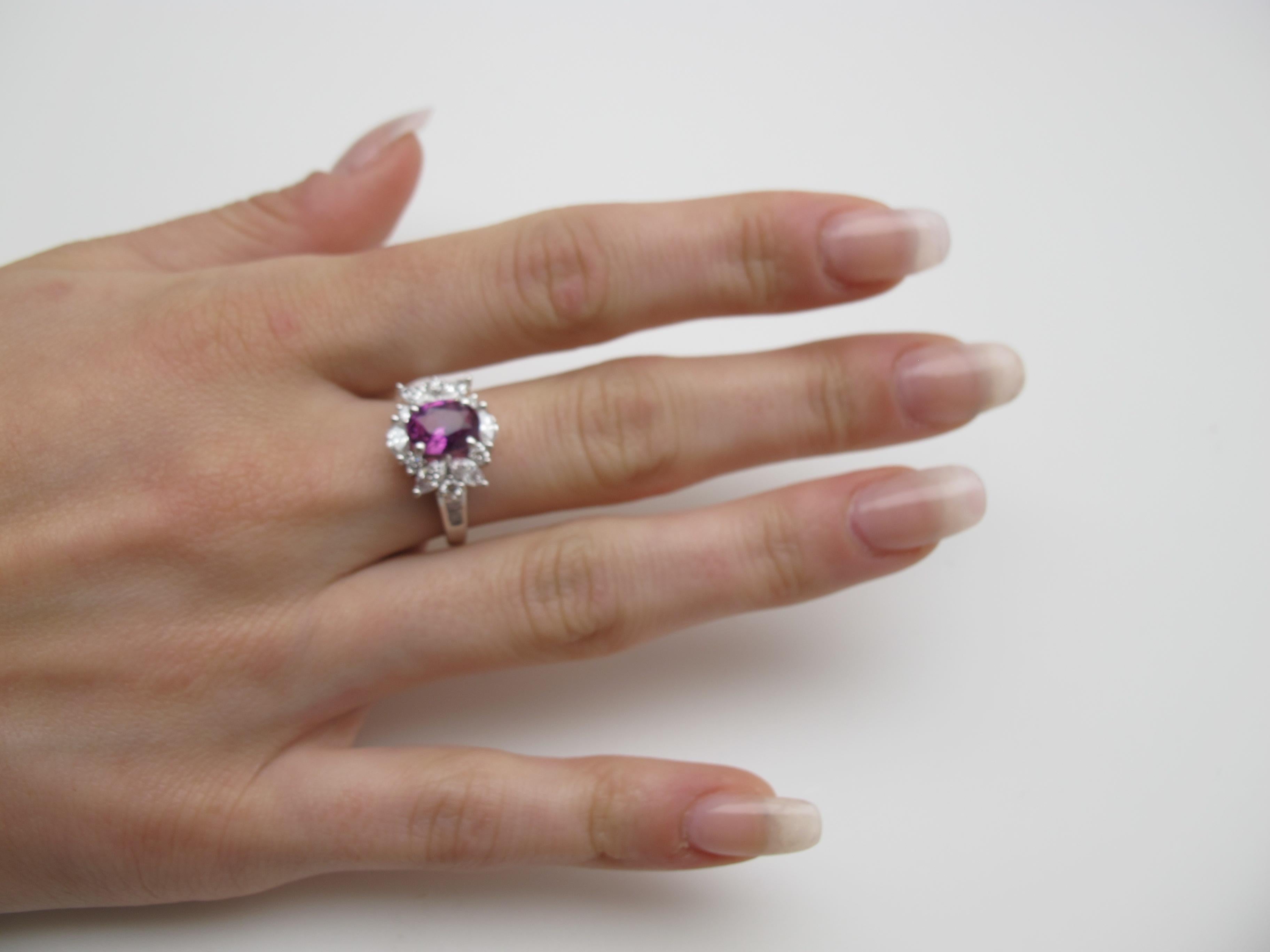 Pretty in pink! This stunning cocktail ring features a 2.27 carat deep pink sapphire of absolutely gem color. Clean, brilliant and beautifully cut, this center stone shines, surrounded by a luxurious arrangement of fine-quality diamonds in round,