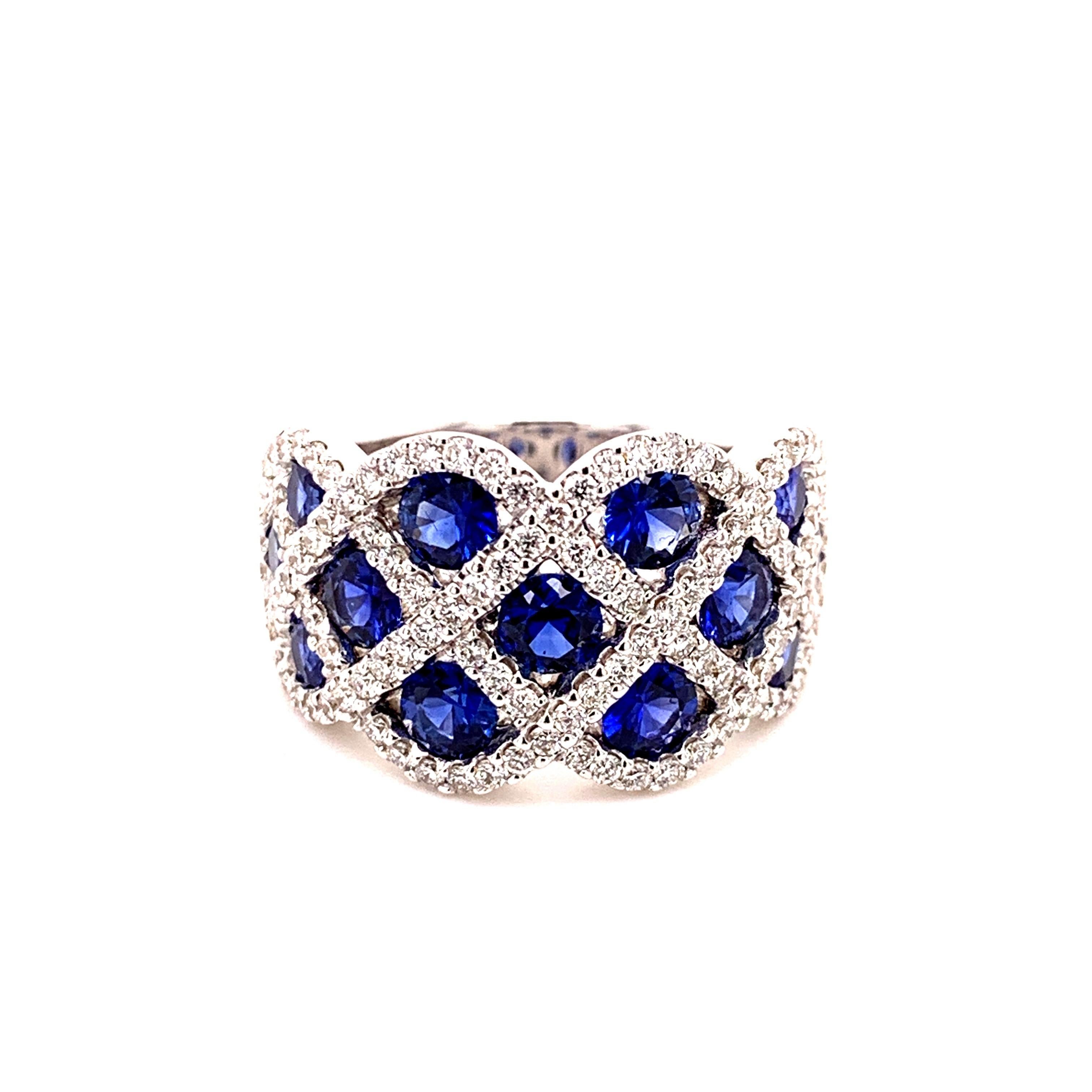 Stunning checkered design sapphire diamond ring. High lustre, round brilliant cut, 2.27 carats, natural royal blue sapphires encased in the invisible mount, accented with round brilliant cut diamonds. Contemporary handcrafted tapered band ring