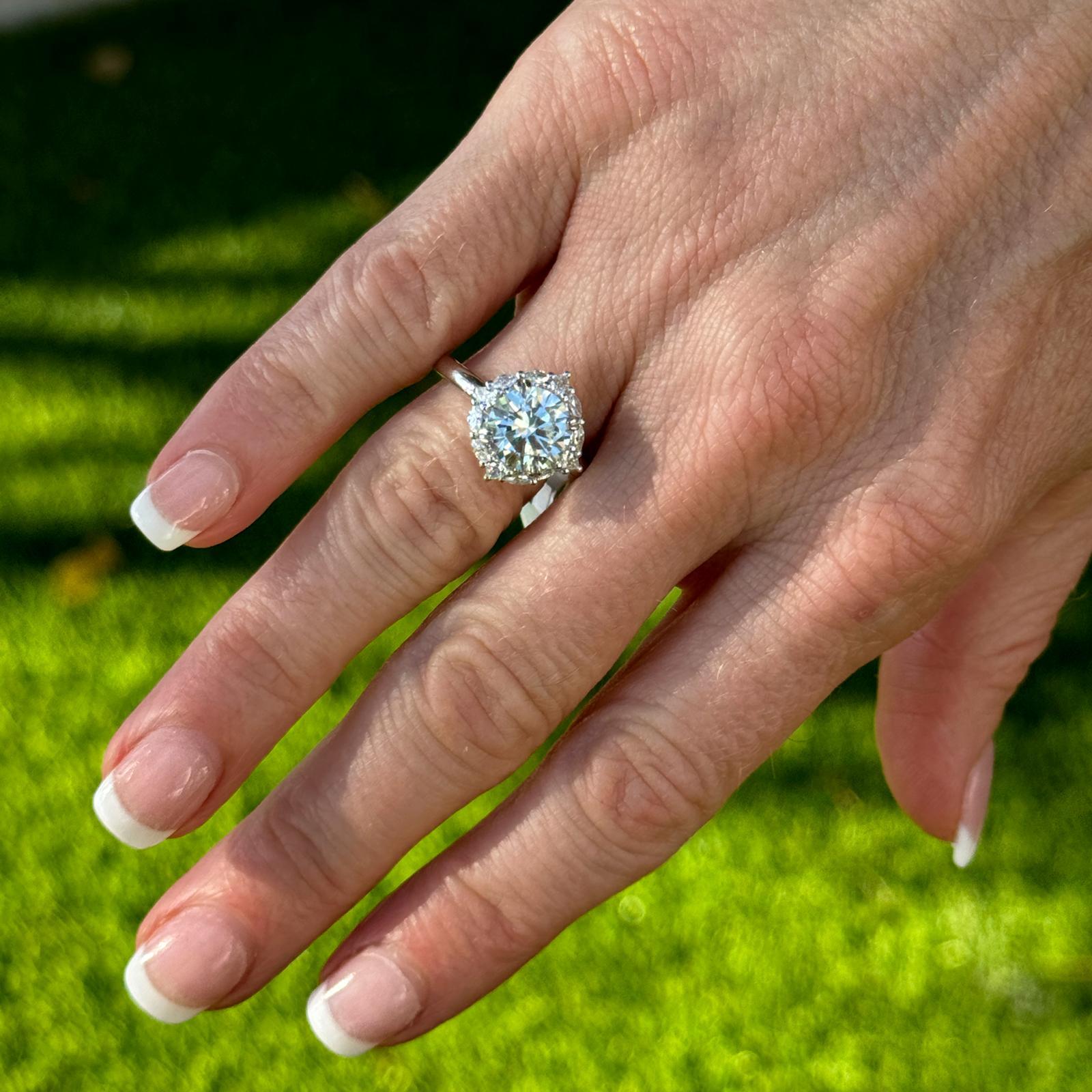 Elegant diamond engagment ring crafted in 14 karat white gold,  designed to highlight the brilliance of the center diamond. The 2.27 carat round brilliant cut diamonds is graded by the GIA K color and SI1 clarity (see the certificate in the photos