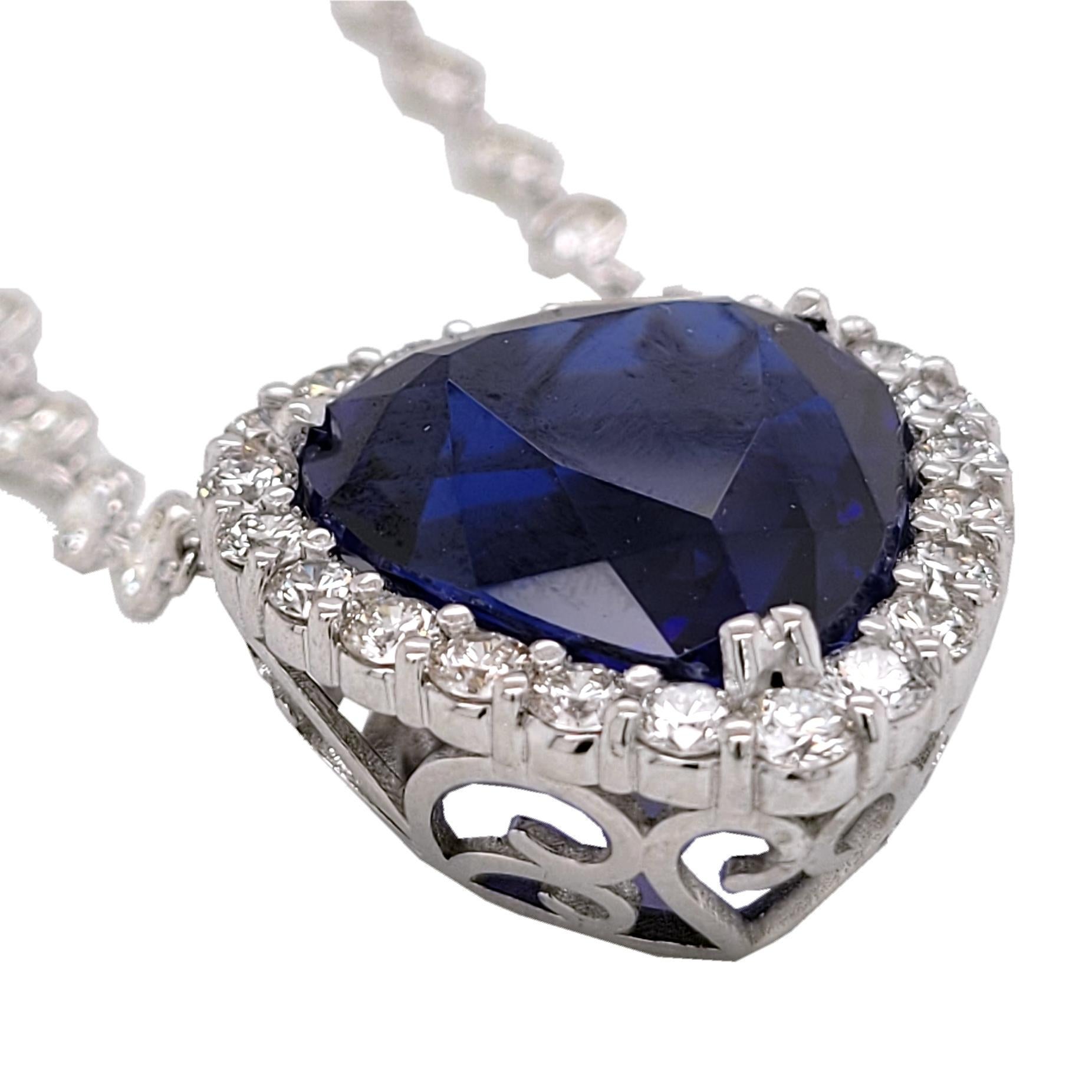 This Beautiful 22.73 Ct Heart Shape Tanzanite is set in a beautiful hand crafted Hear shape Pendant with Halo (with 22 perfectly matched 2.7 mm Round Brilliant diamond) hanging on a 16 inch diamond by the Yard Necklace with 53 Perfectly matched 2.8