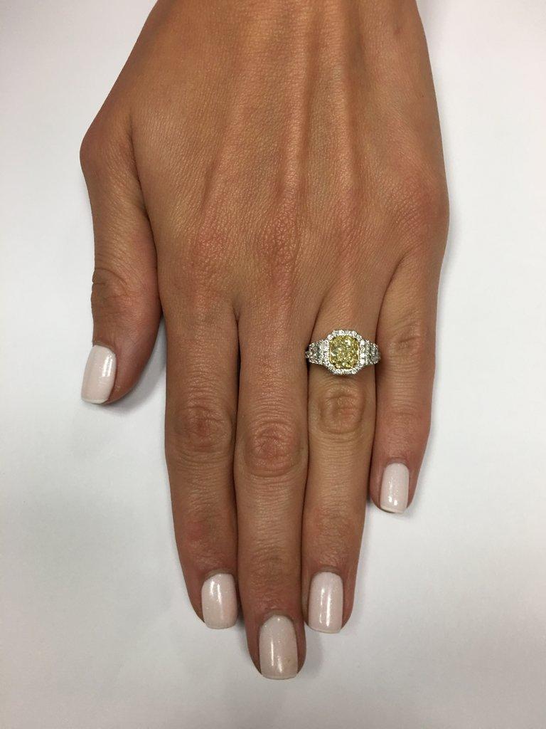 Spectacular in every way! this 2.28 ct fancy yellow radiant cut diamond engagement ring is a positively bold look. GIA certified at Fancy Yellow-SI1, the canary diamond has a rich color, eye clean and sparkles tremendously. The facets of this