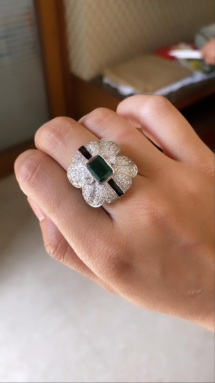 A gorgeous and chic natural emerald ring set in 18k white gold with black enamel and diamonds.  The Natural emerald originates from Zambia, Emerald weight is 2.28 carats and natural diamond weight is 1.66 carats. The ring dimensions in cm 2.5 x 2.2